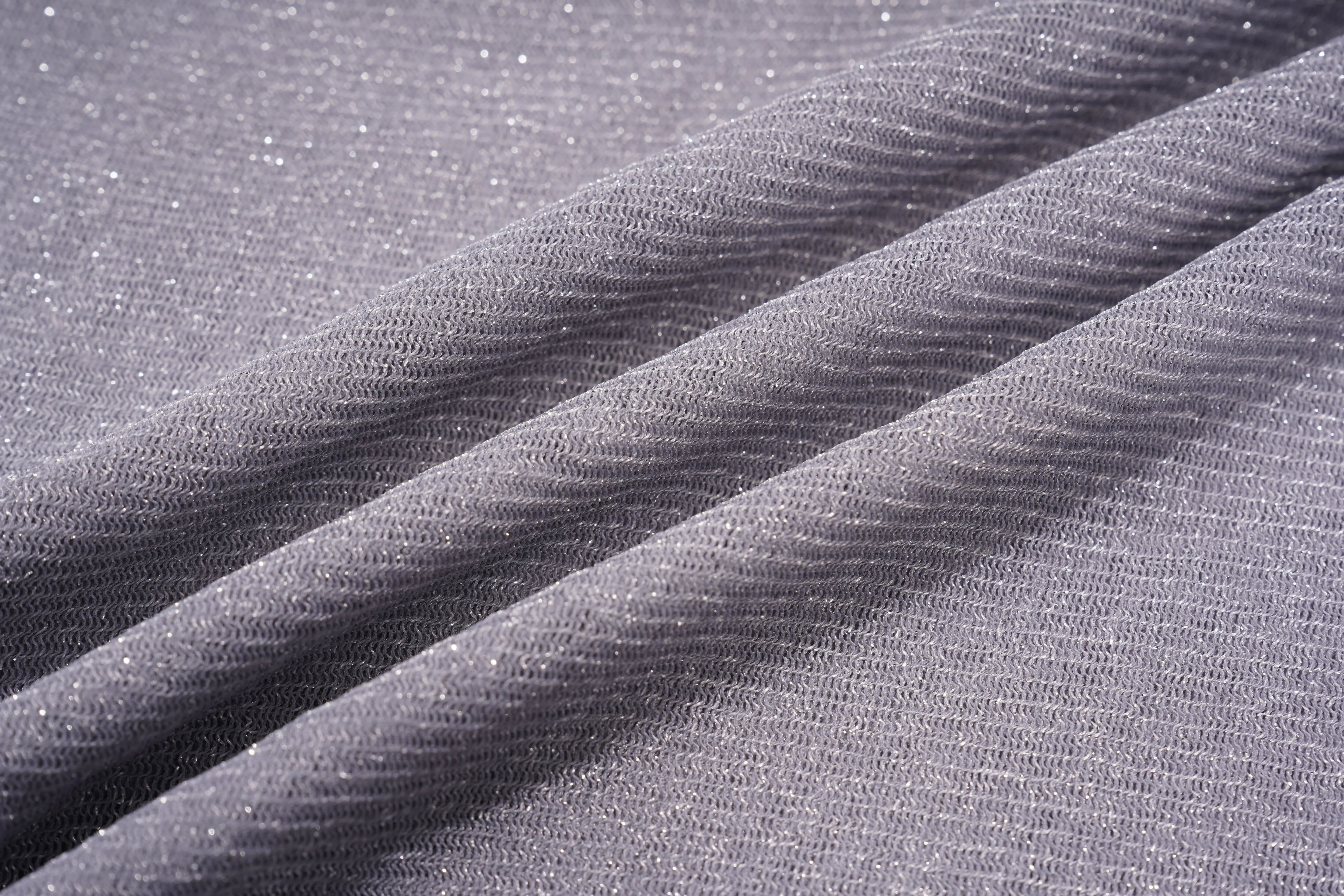 Close-up of gray textured fabric with folds, TCH Grey Rhinestone Purple Wings Long Sleeve Top