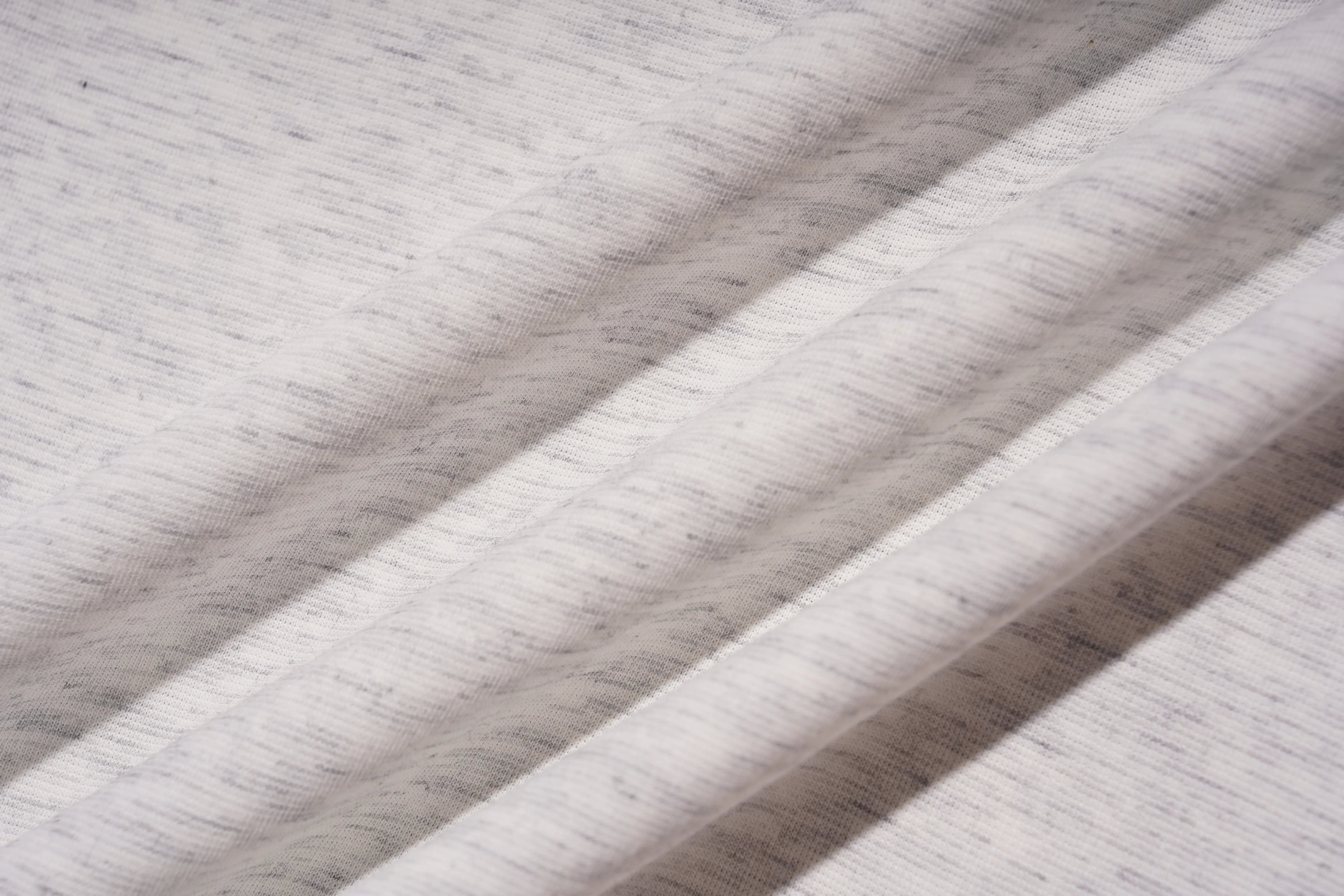 Close-up of gray fabric with a textured pattern, TCH Grey Rhinestone Unicorn Graphic T-Shirt