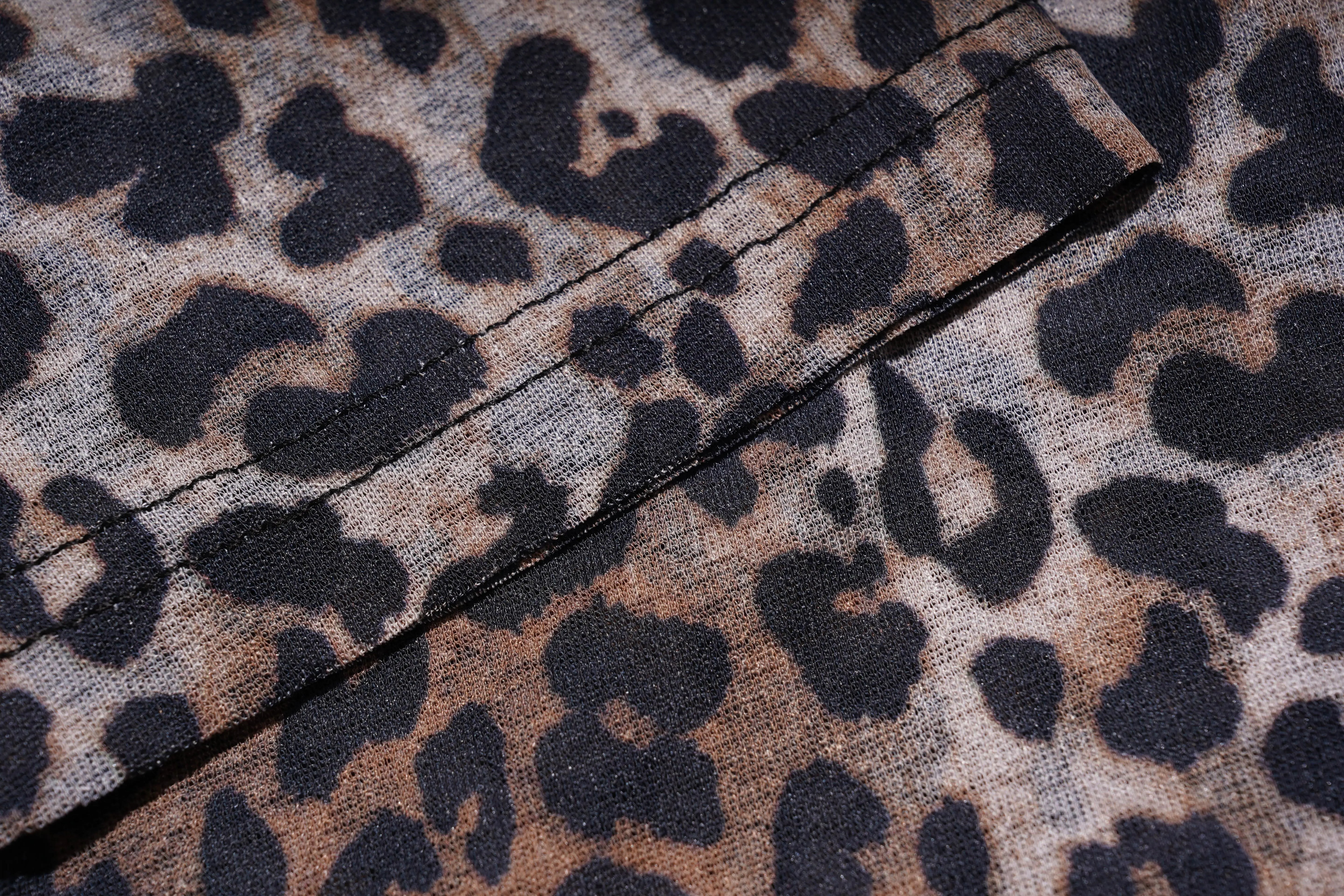 Close-up of leopard print fabric with a visible seam. TCH Leopard Print Rhinestone Butterfly Fitted T-Shirt