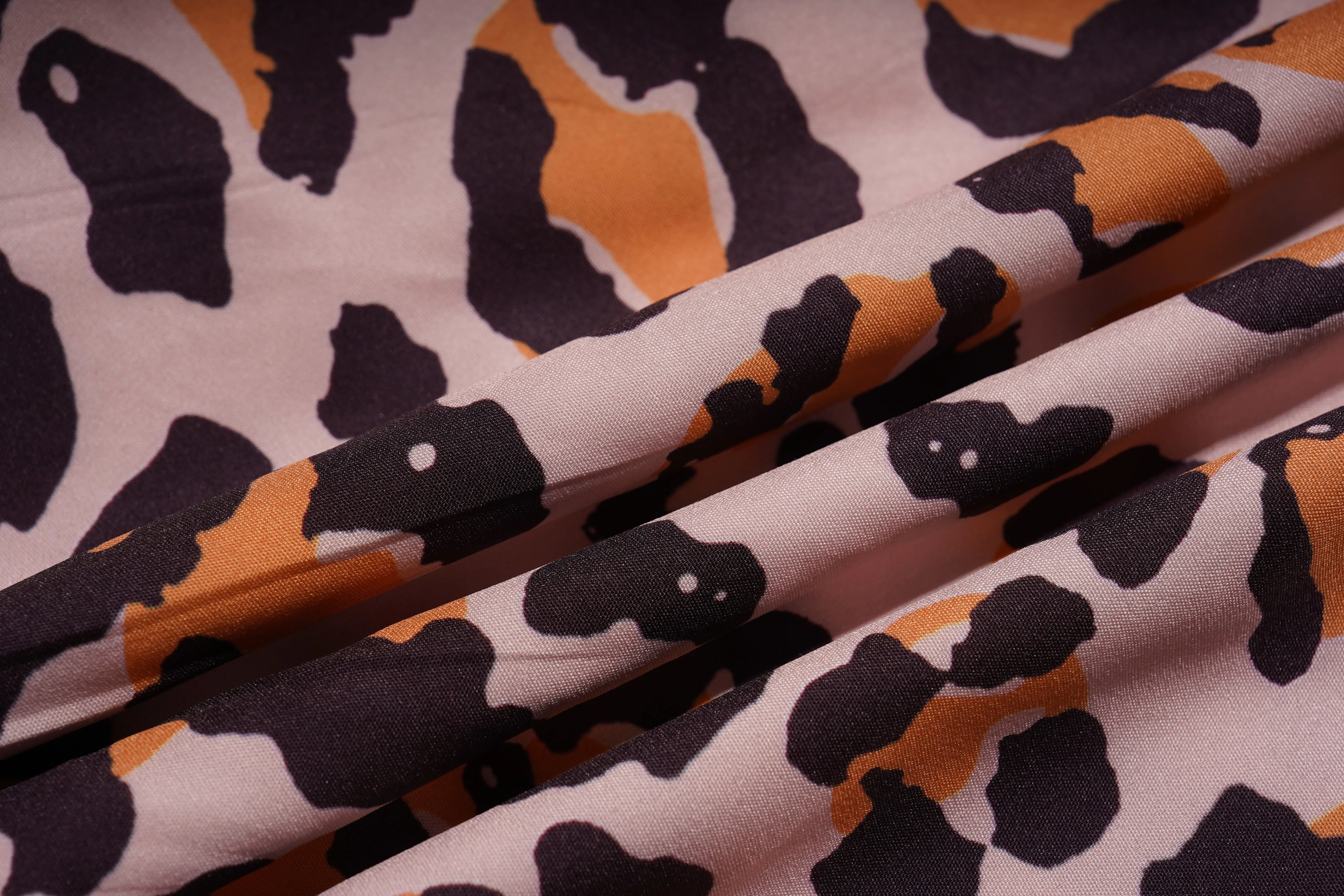 Close-up of fabric with black and orange pattern on a white background, TCH Leopard Rhinestone Animal Embellished Dress