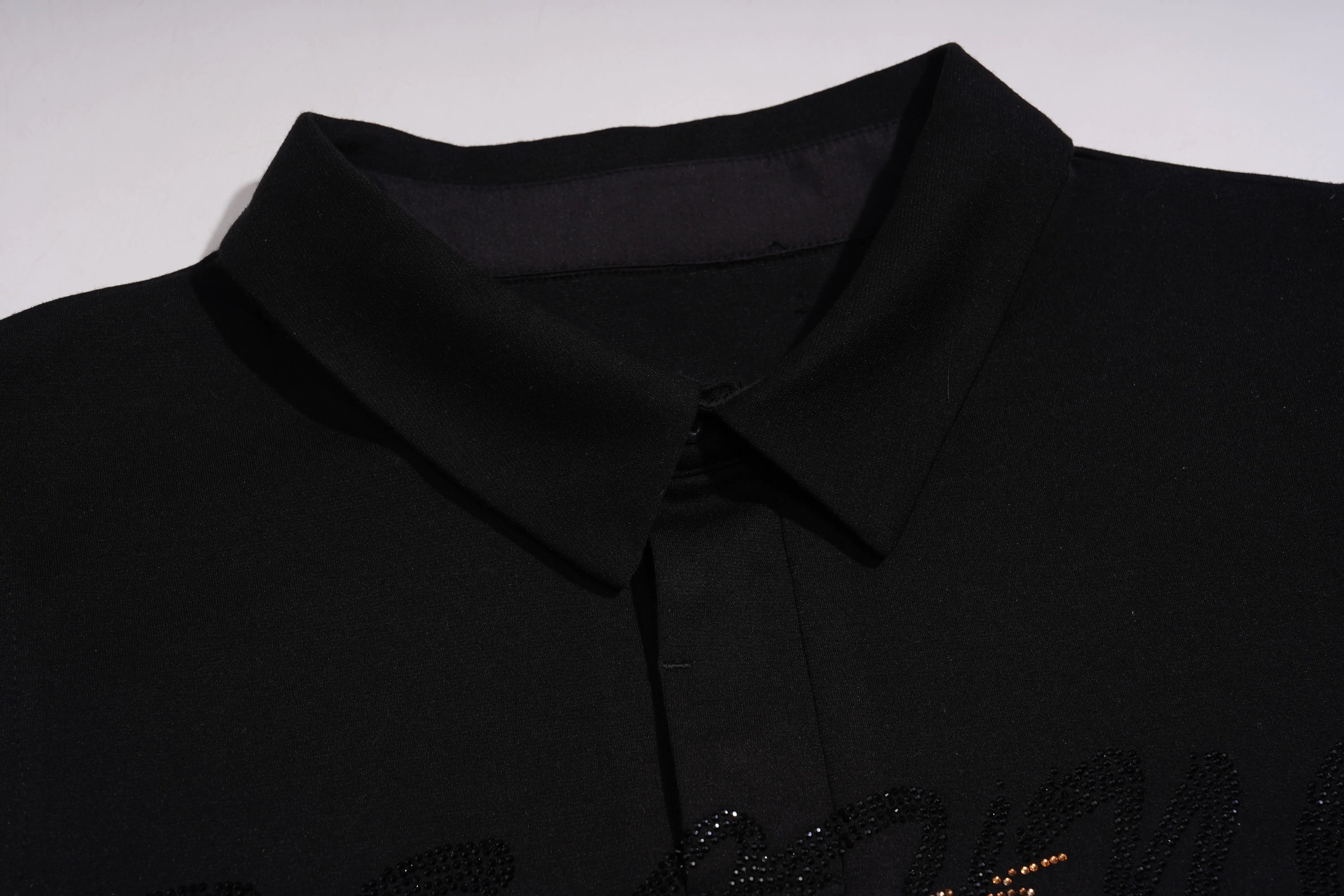 Close-up of a black polo shirt with a collar detail on a white background, TCH Leopard Rhinestone Sleeveless Polo Shirt