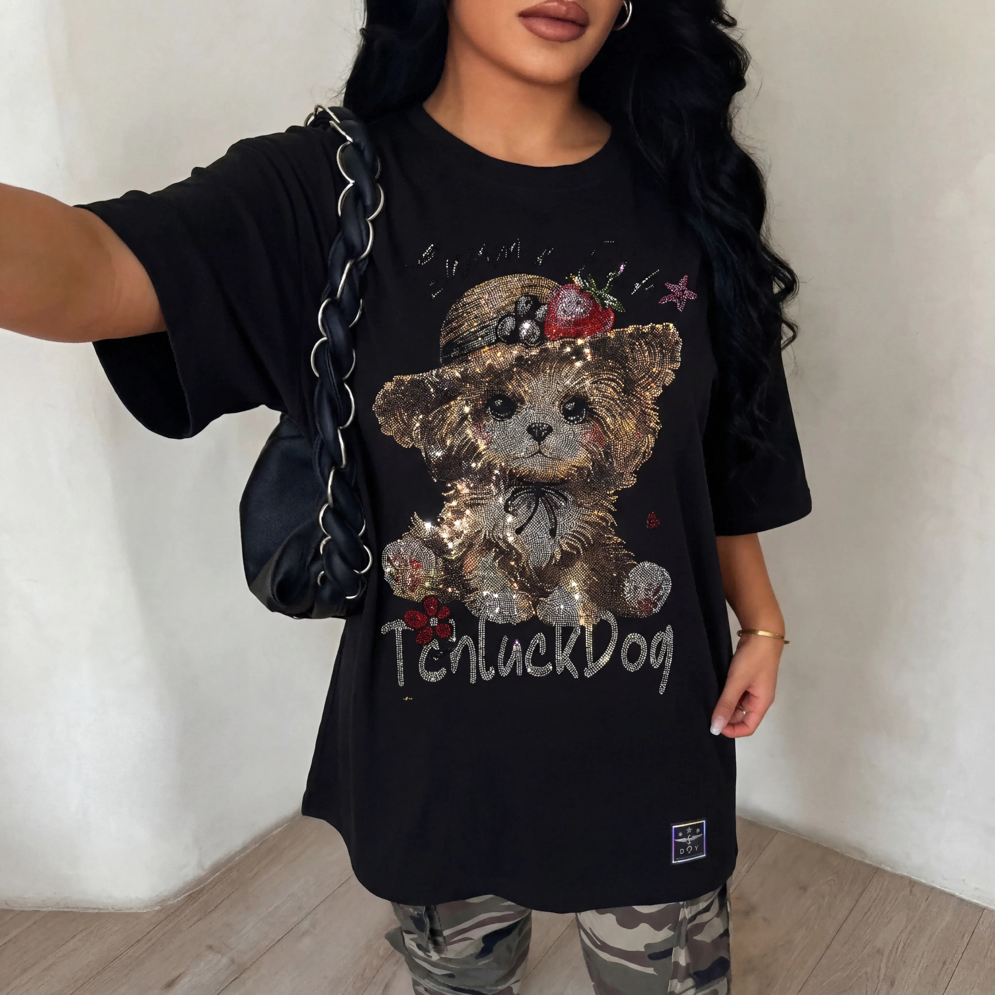 Person wearing a black t-shirt with a teddy bear graphic and 'TenluckDog' text. TCH Luck Dog Rhinestone T-Shirt