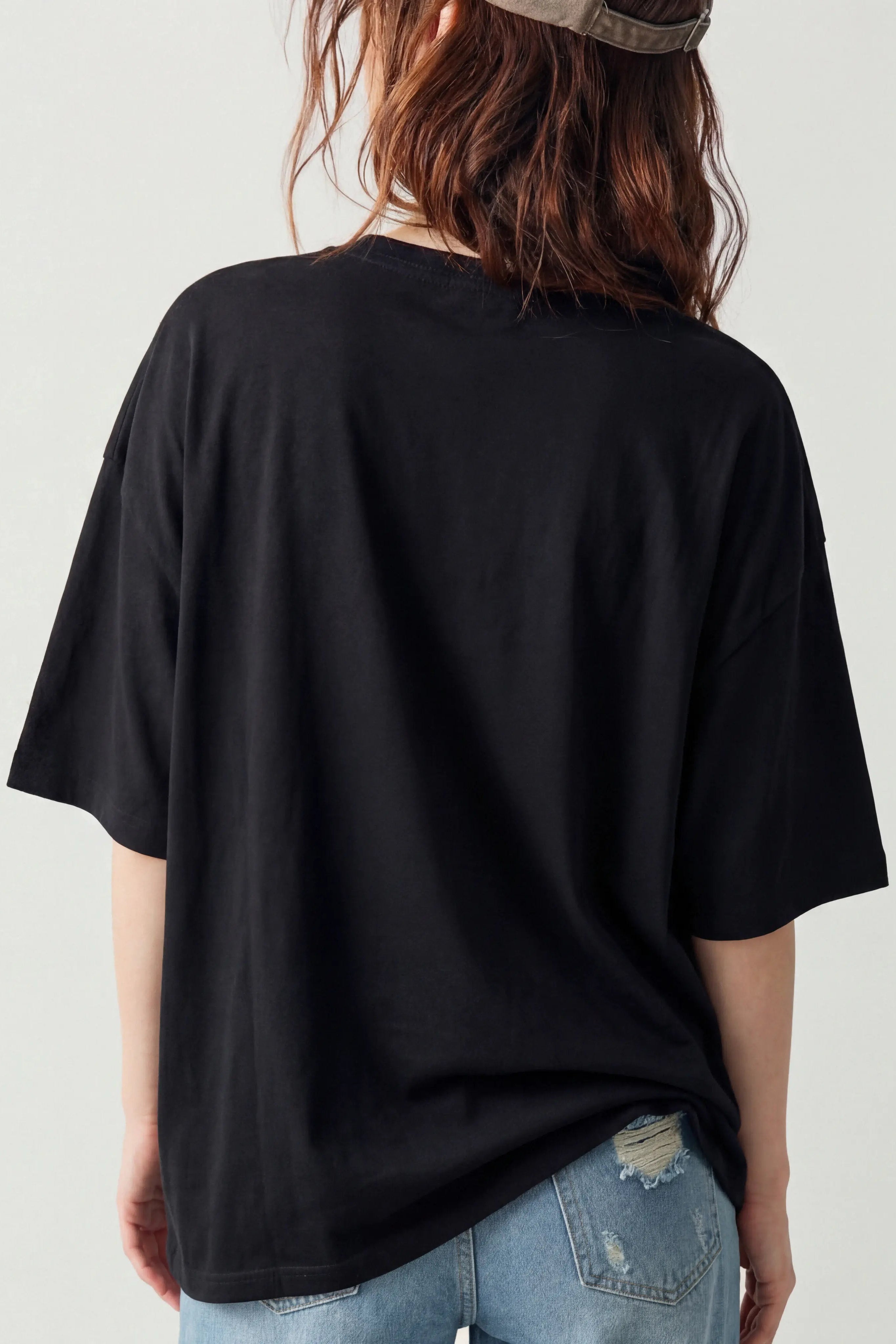 Person wearing an oversized black t-shirt and light blue jeans on a plain background, TCH Luck Dog Rhinestone T-Shirt