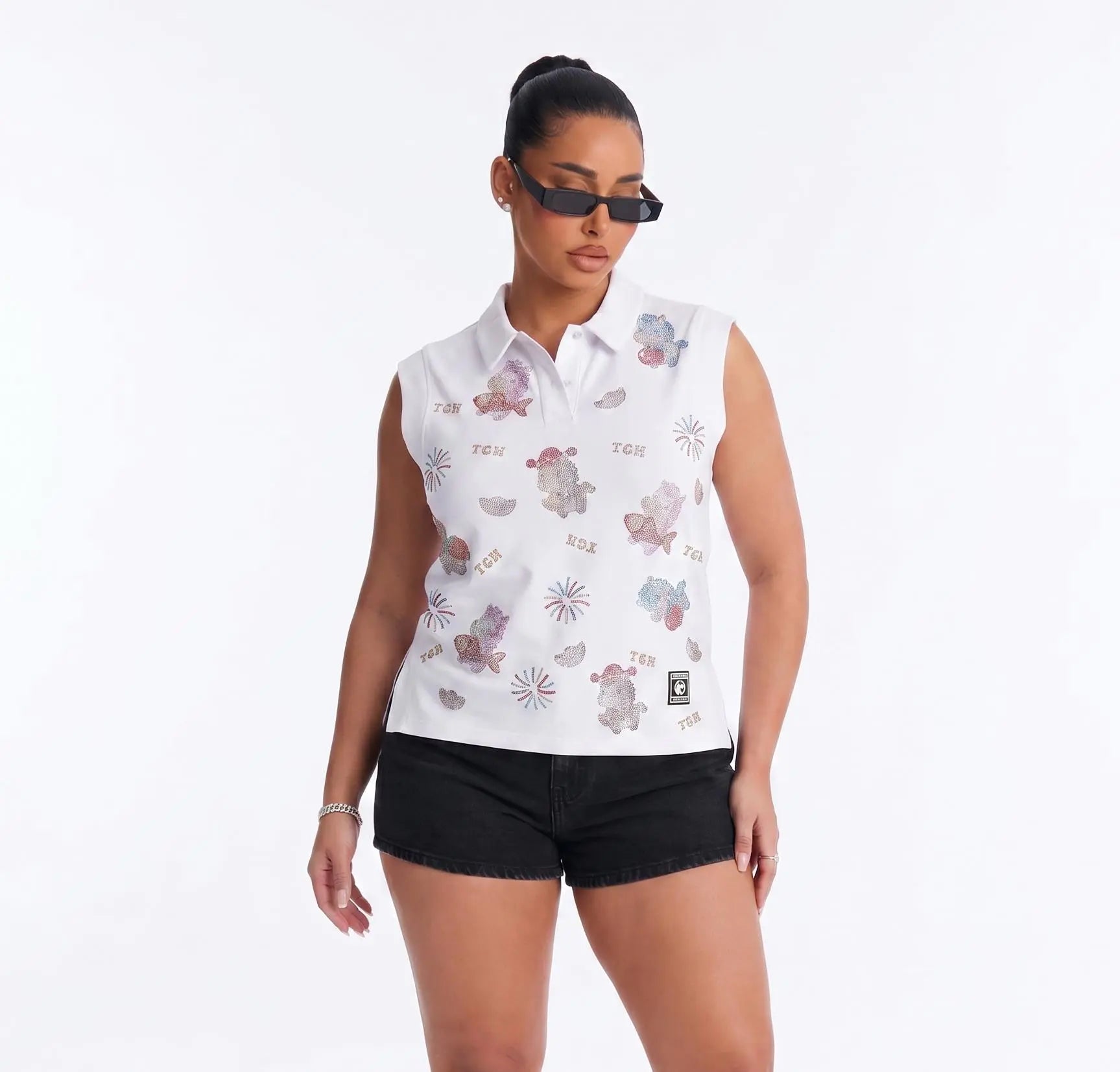 Woman wearing a sleeveless floral blouse and black shorts on a white background, TCH Lucky Pony Rhinestone Sleeveless Polo Shirt