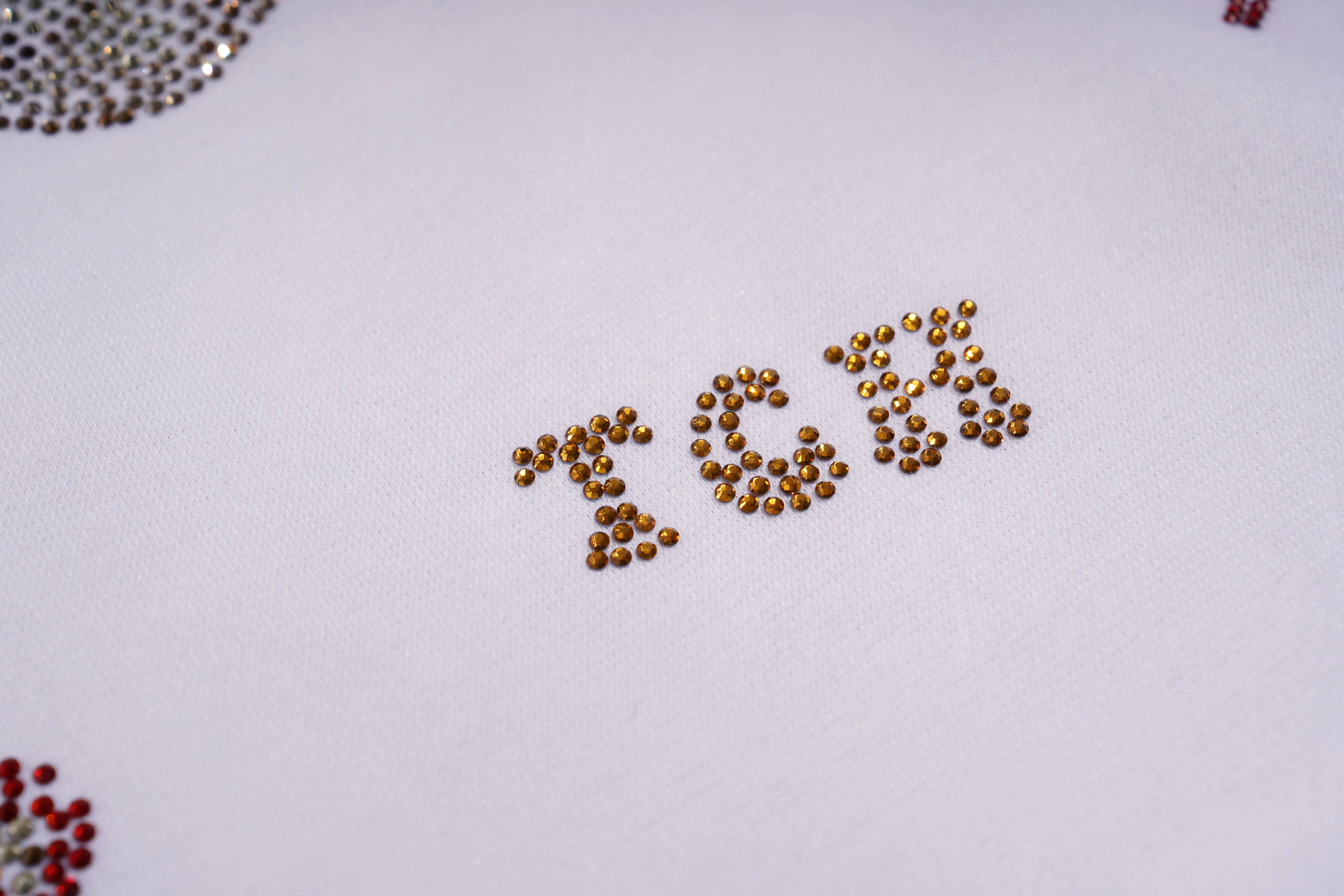 Gold rhinestones spelling out '26%' on a white background, TCH Lucky Pony Rhinestone Sleeveless Polo Shirt