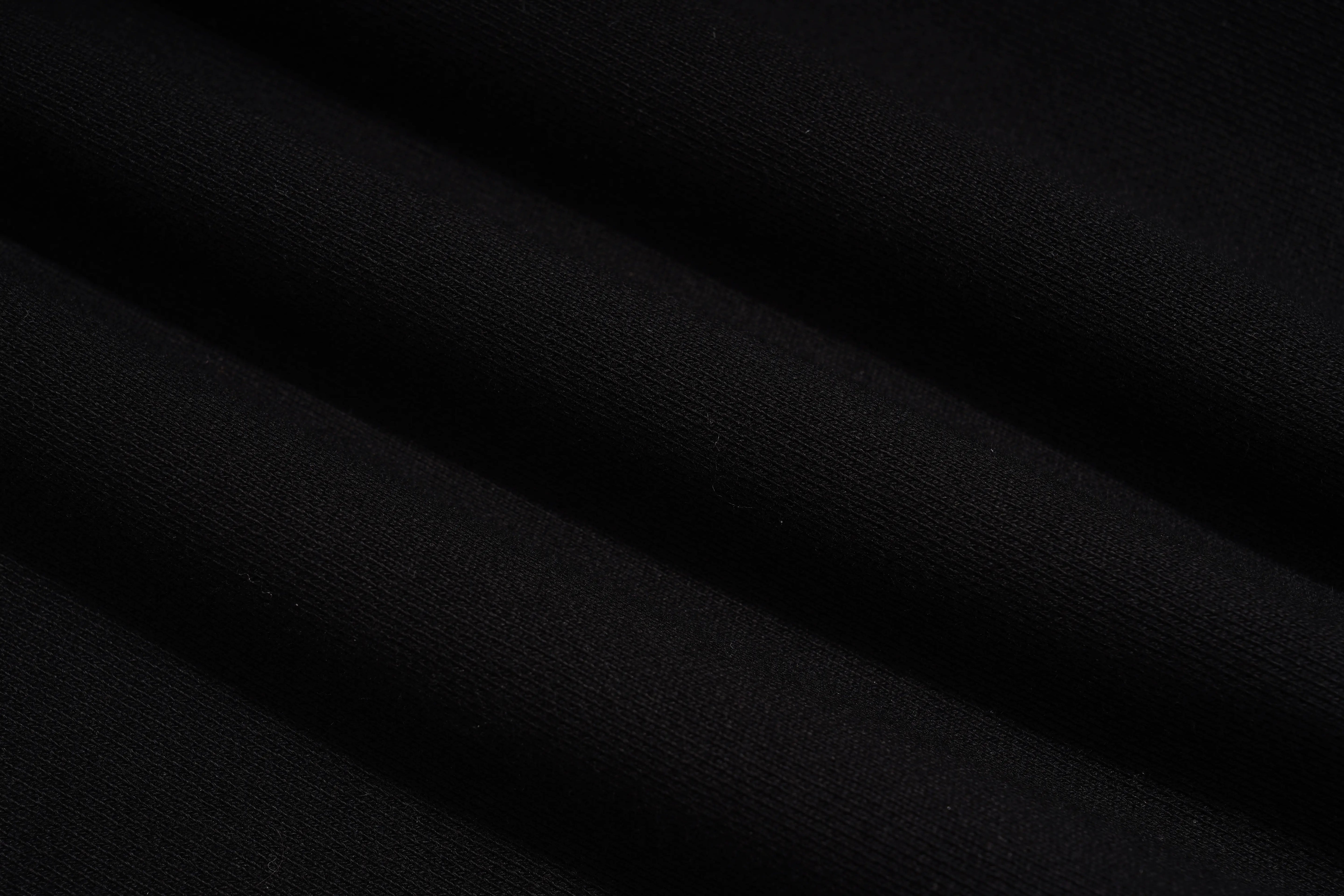 A close-up of draped black fabric with soft folds showing a fine woven texture. TCH Luxury Gold Dragon Rhinestone Graphic Black Sweatshirt