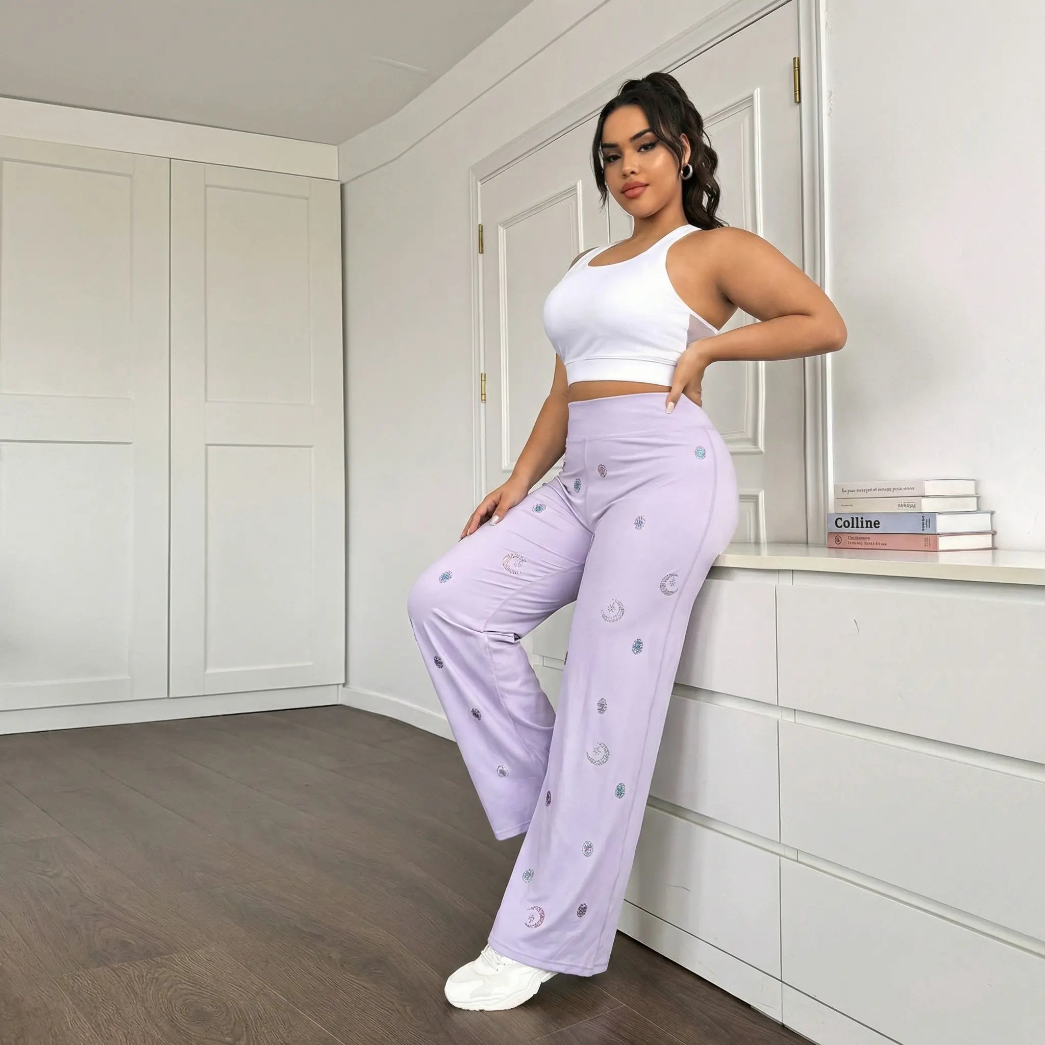 Woman in a white top and lavender pants posing in a room with white cabinets. TCH Moonlight Rhinestone Wide-Leg Pants