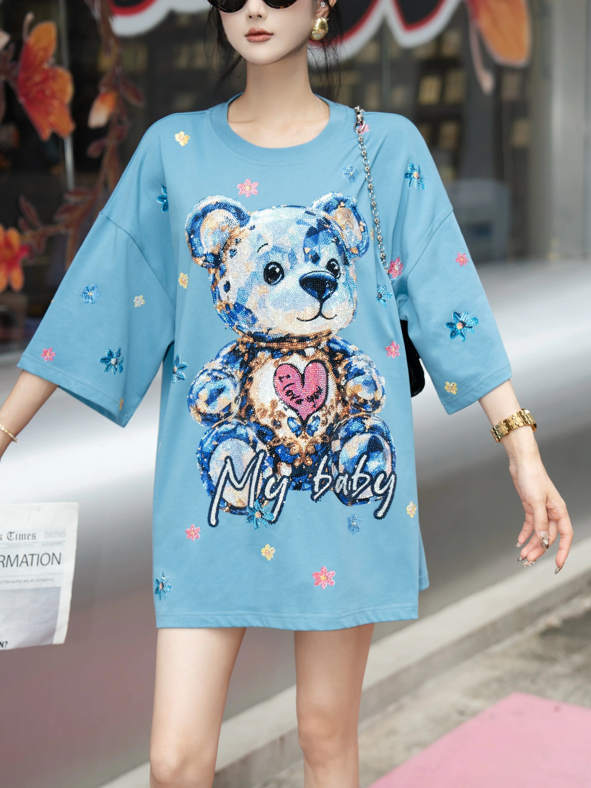 Person wearing a blue dress with a teddy bear design in an urban setting, TCH My Baby Rhinestone Bear Oversized Blue T-Shirt
