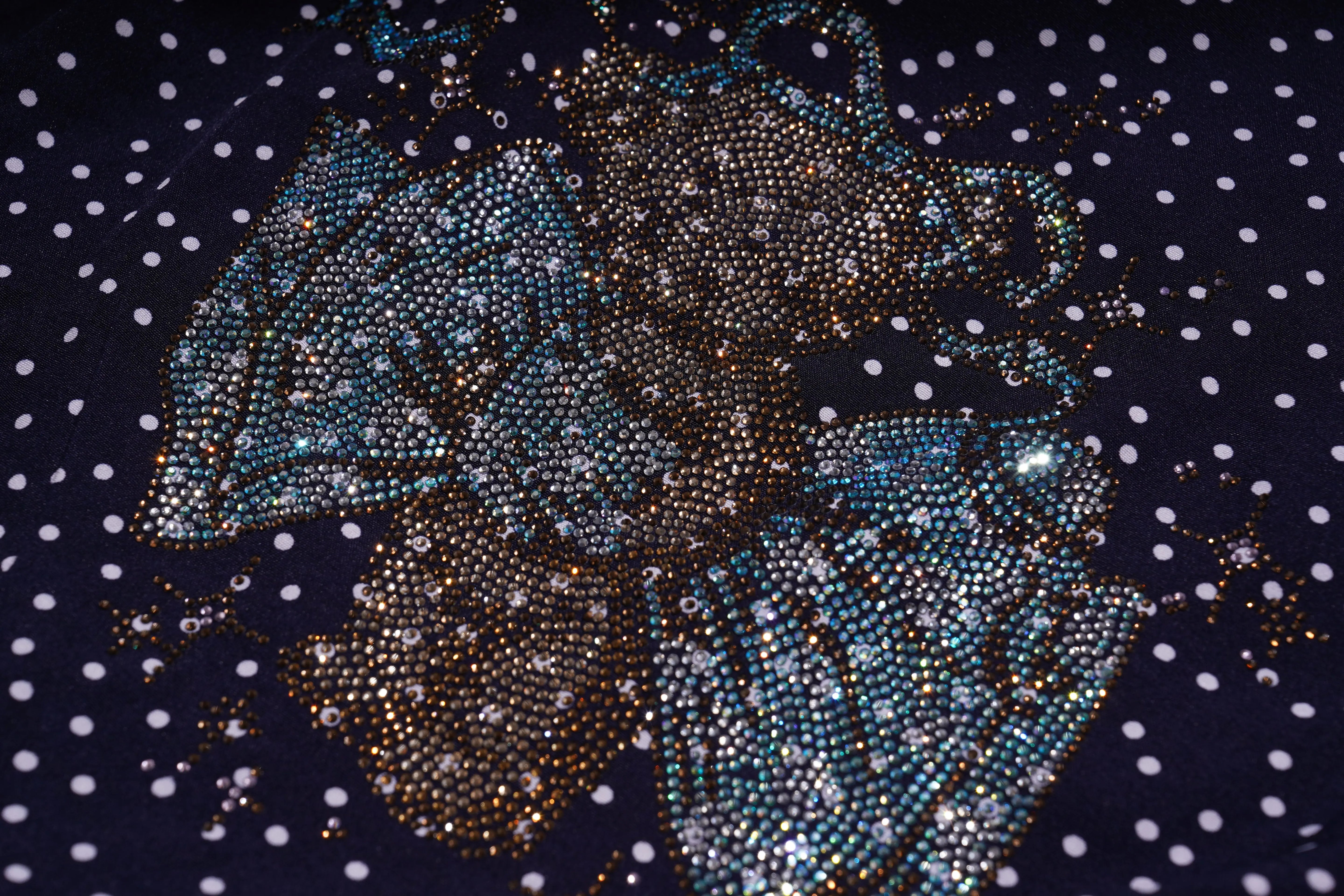 Decorative fabric with a floral pattern made of sequins on a dark background with white polka dots. TCH Navy Teddy Bear Bow Rhinestone Dress
