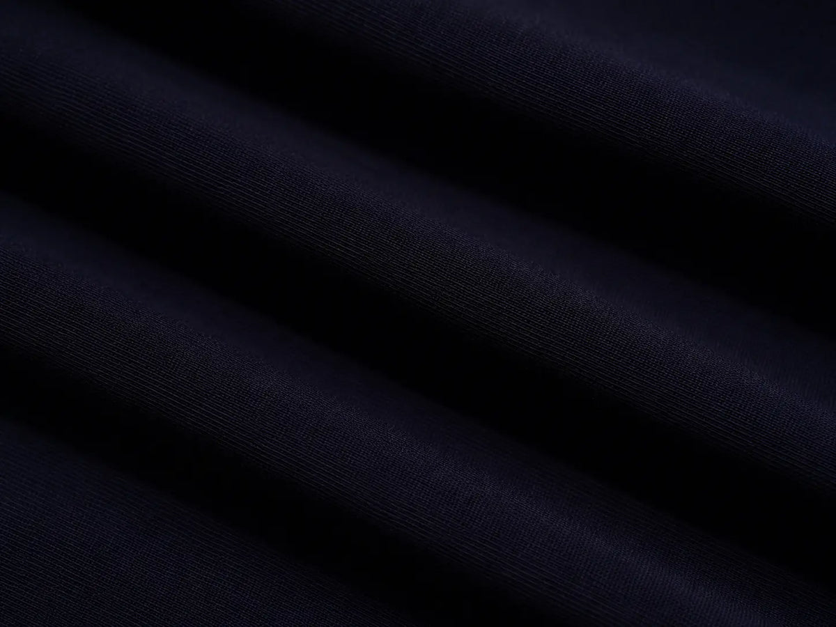 A close-up of dark navy blue fabric with soft diagonal folds and a smooth texture. TCH Navy Teddy Bear Rhinestone Zip Hoodie