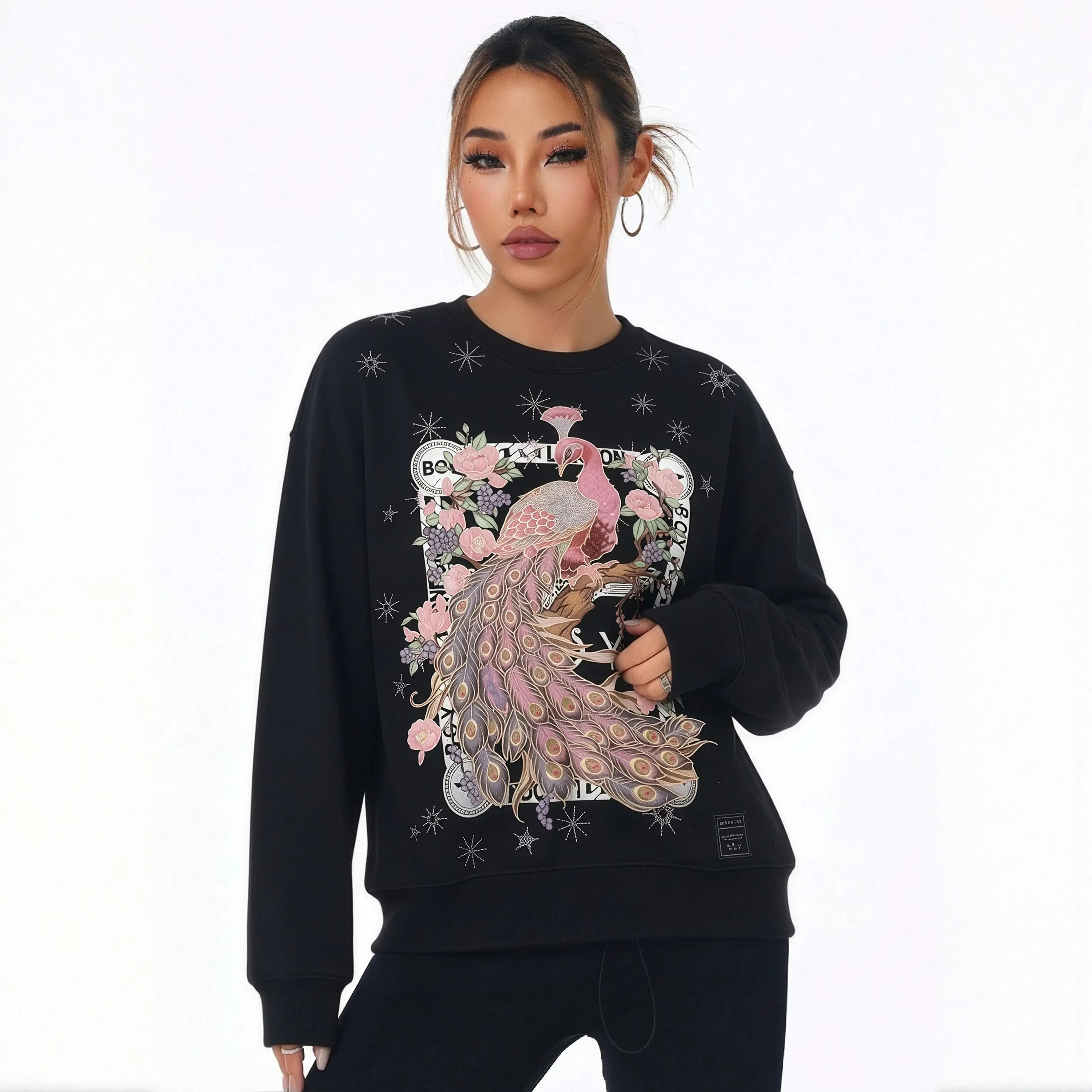 Person wearing a black sweatshirt with a colorful peacock design on a white background， TCH Peacock Embroidered Rhinestone Sweatshirt