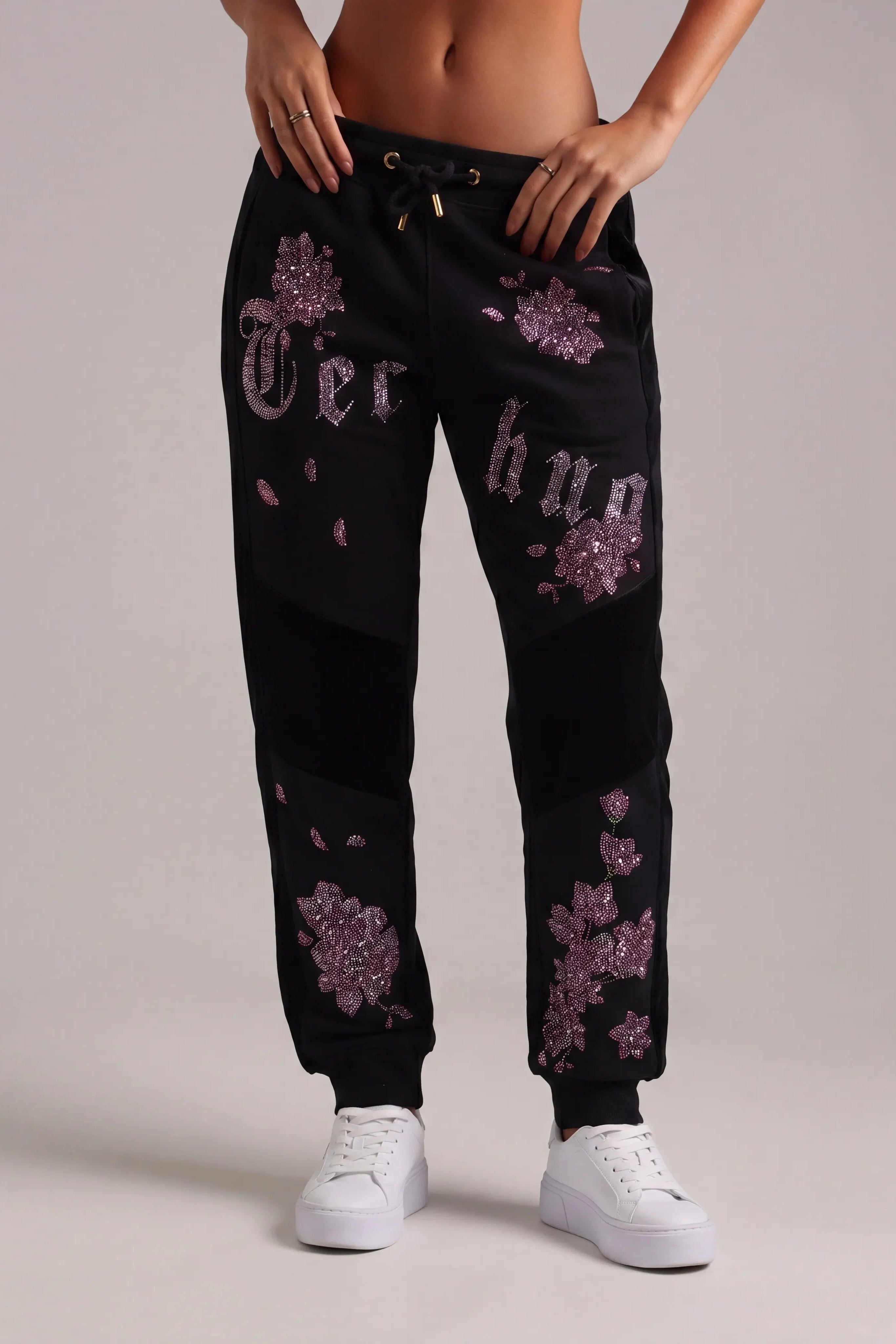 Black jogger pants with purple floral patterns worn by a person on a plain background, TCH Pink Blossom Rhinestone Jogger Pants