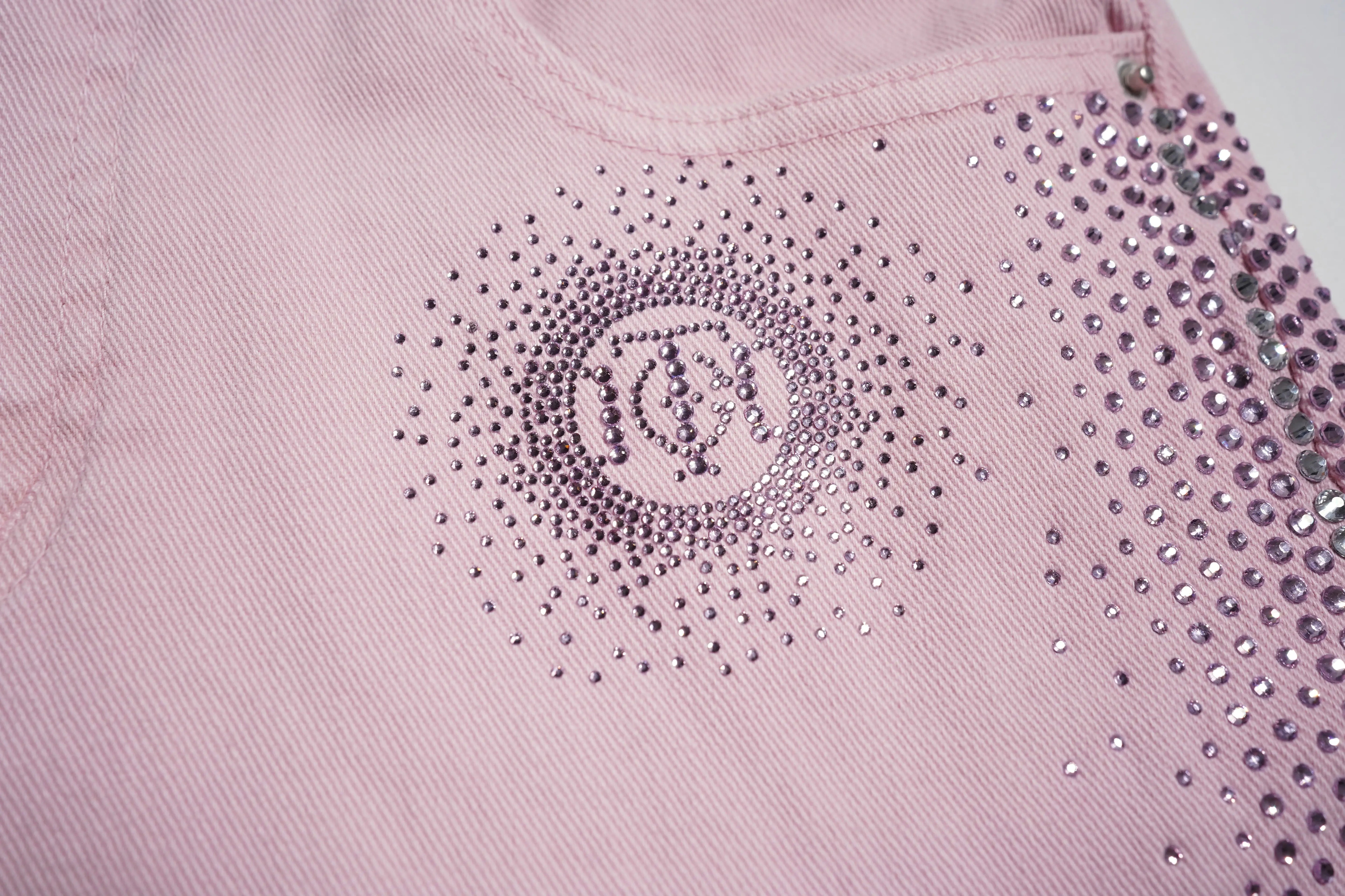 Close-up of a pink garment with rhinestone embellishments, TCH Pink Rhinestone Gradient Denim Jeans with Logo Detail