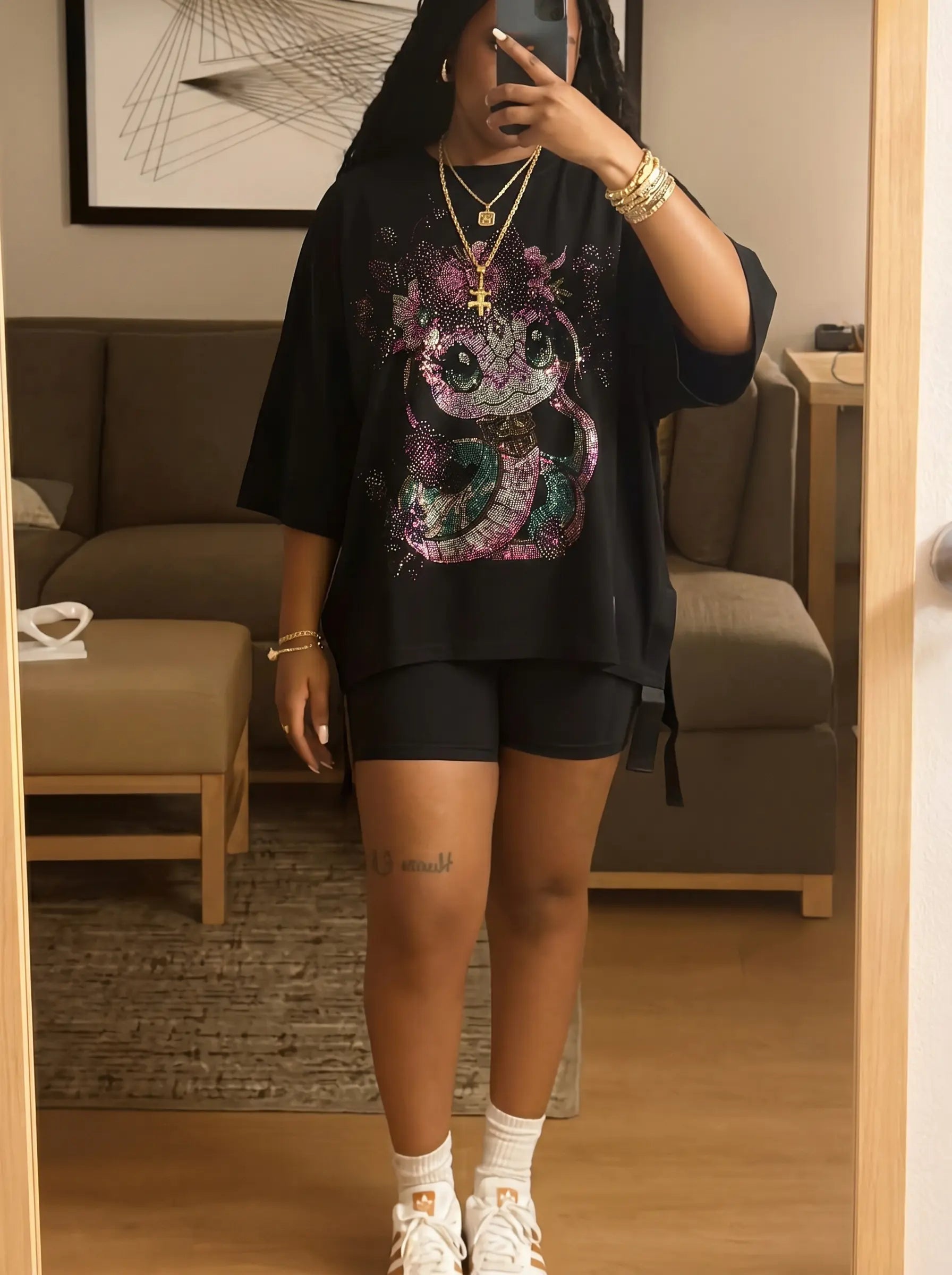 Person wearing a black oversized shirt with a colorful graphic design in a room. TCH Pink Snake Rhinestone Oversize T-Shirt
