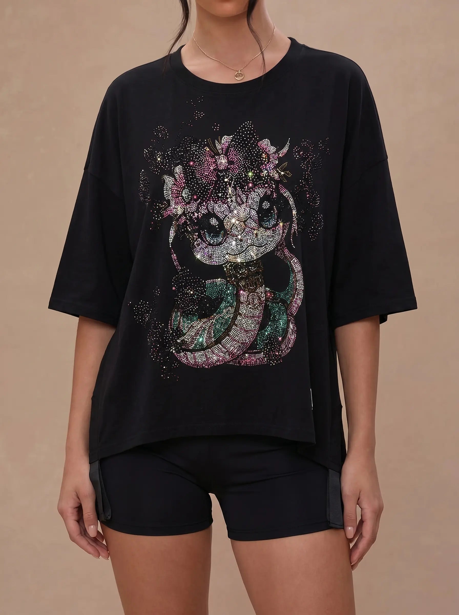 Person wearing a black t-shirt with a decorative cat design on a beige background, TCH Pink Snake Rhinestone Oversize T-Shirt