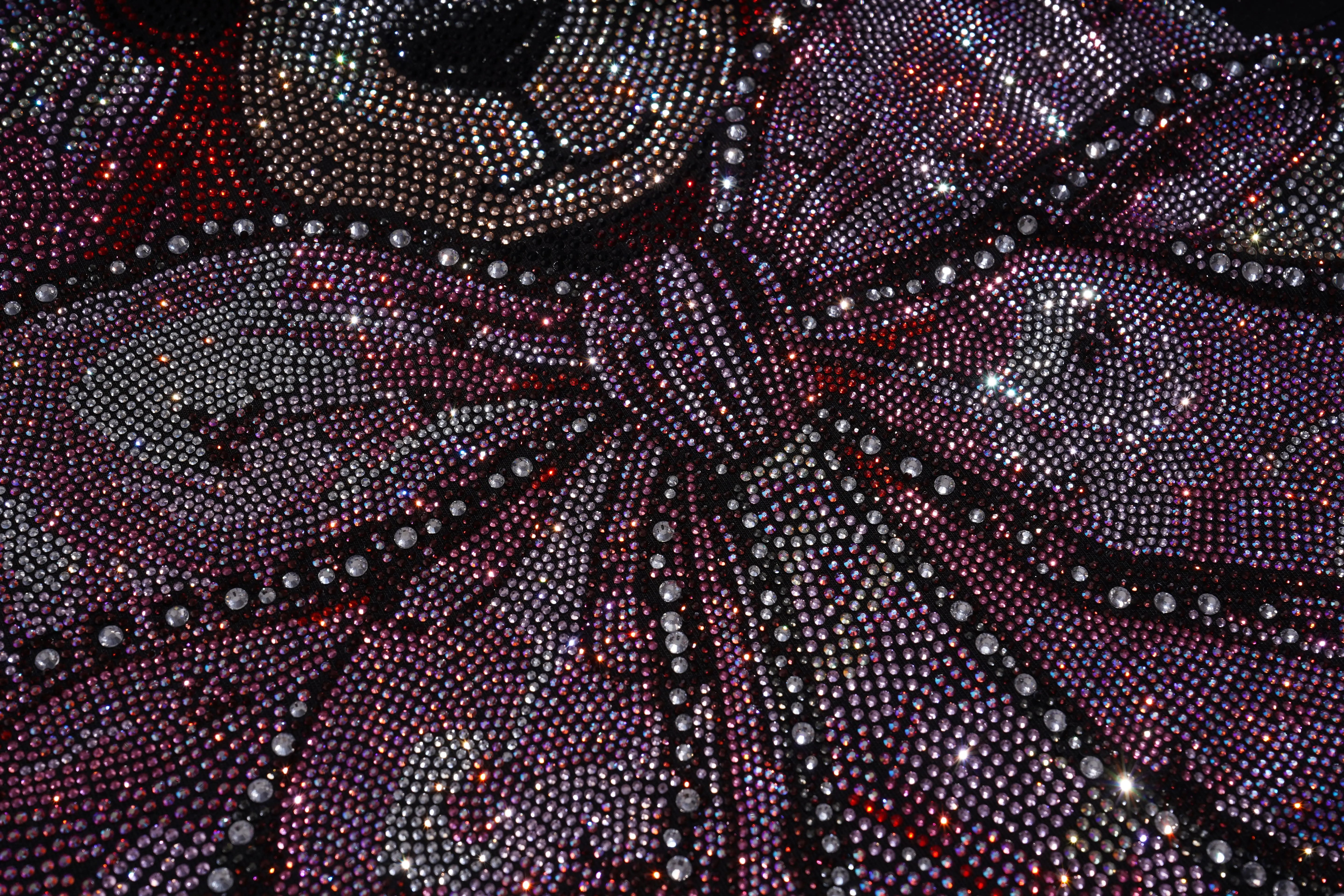 Close-up of a decorative fabric with purple and black pattern, TCH Pink Teddy Bear Rhinestone T-Shirt