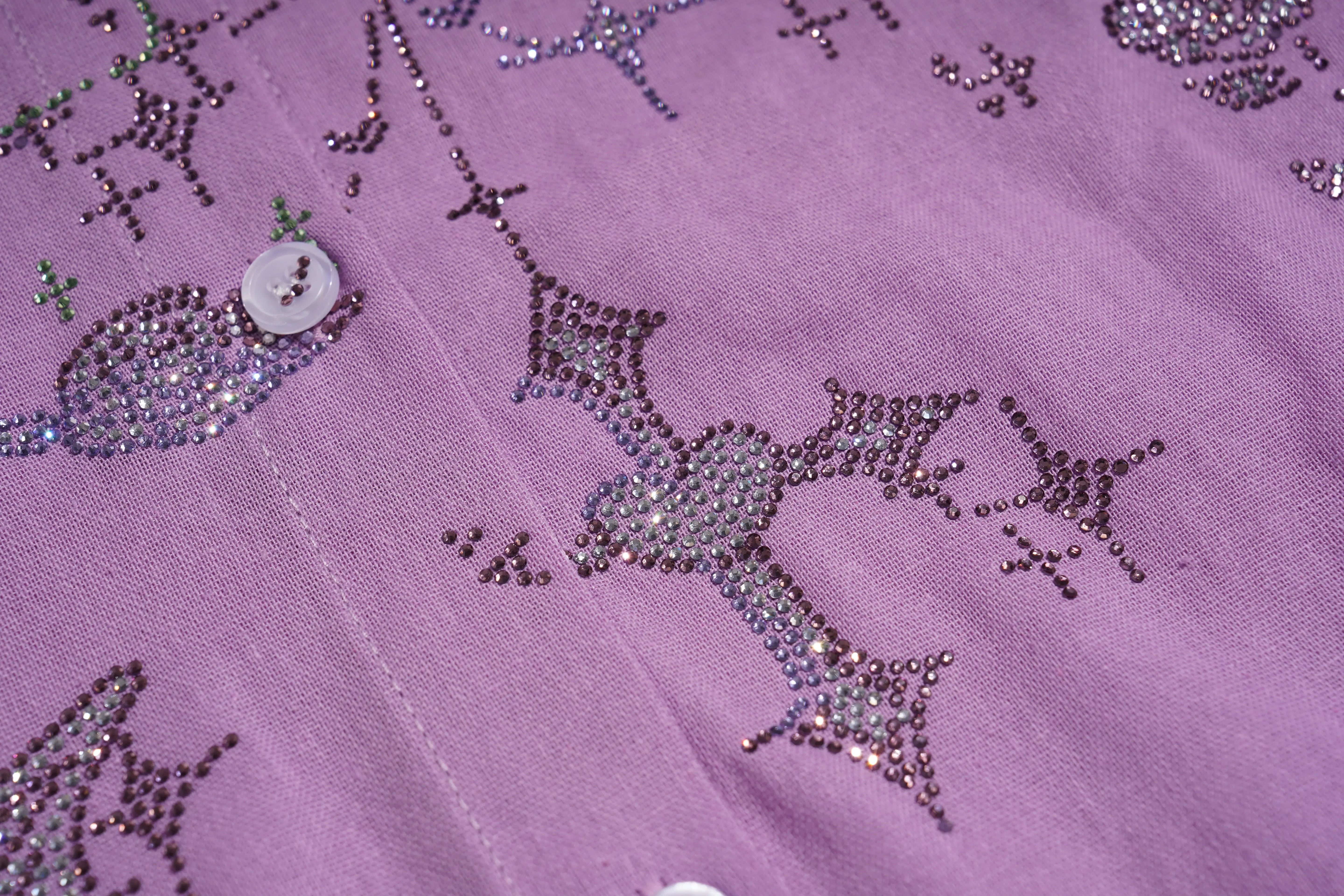 Close-up of a purple fabric with star-shaped bead patterns, TCH Purple Rhinestone Butterfly Set