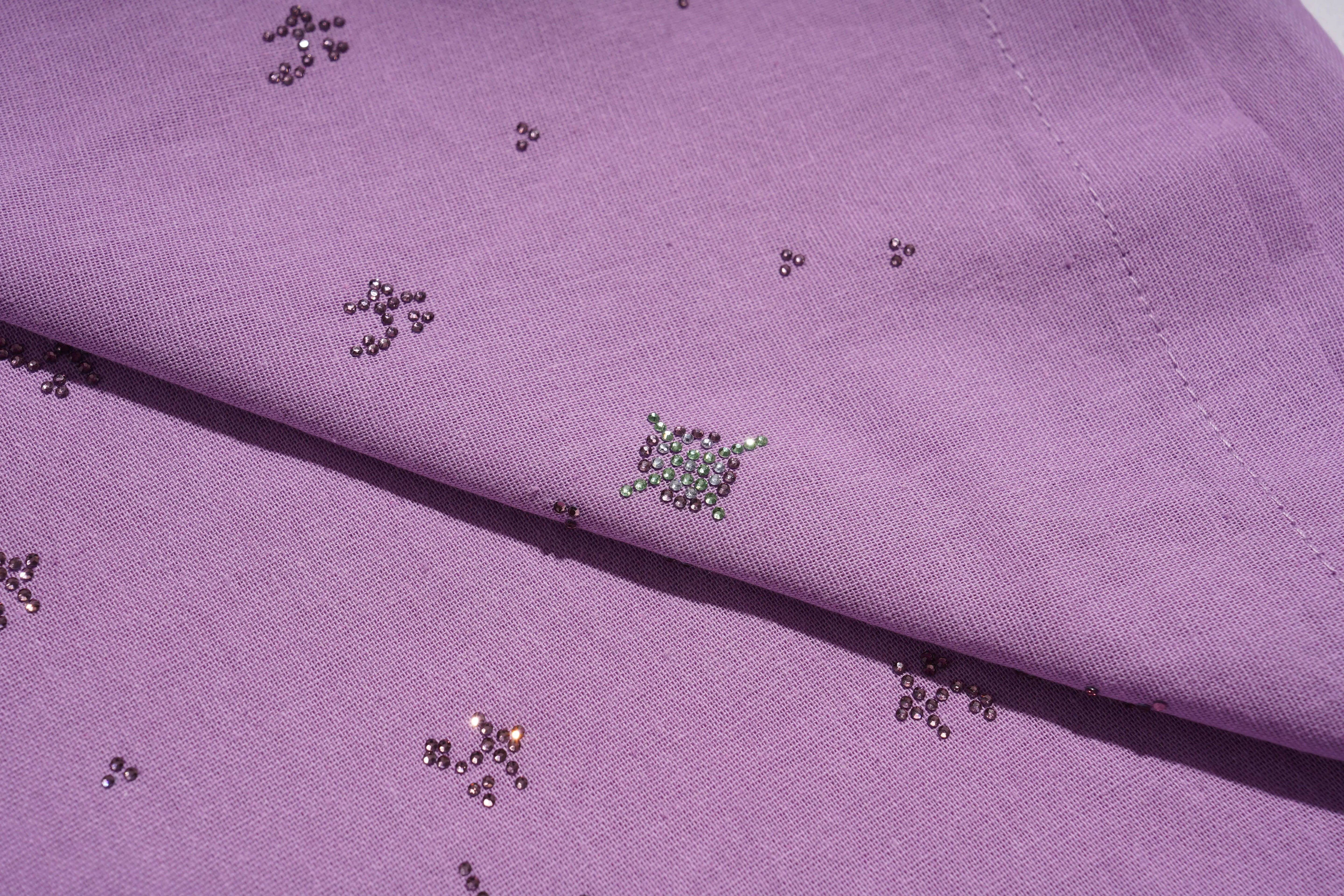 Close-up of purple fabric with small embellishments, TCH Purple Rhinestone Butterfly Set