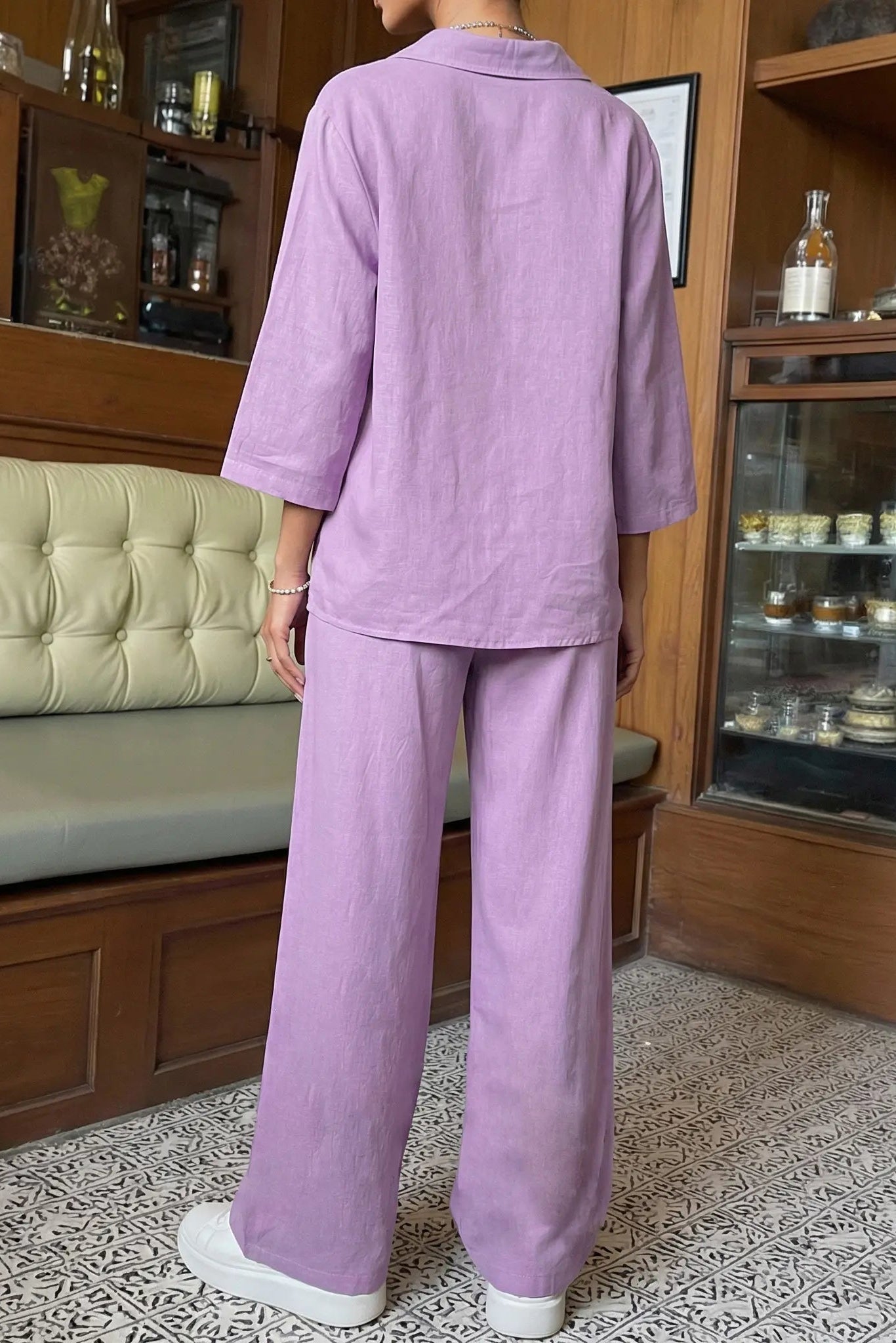 Person wearing a purple outfit standing in a room with wooden furniture and shelves. TCH Purple Rhinestone Butterfly Set
