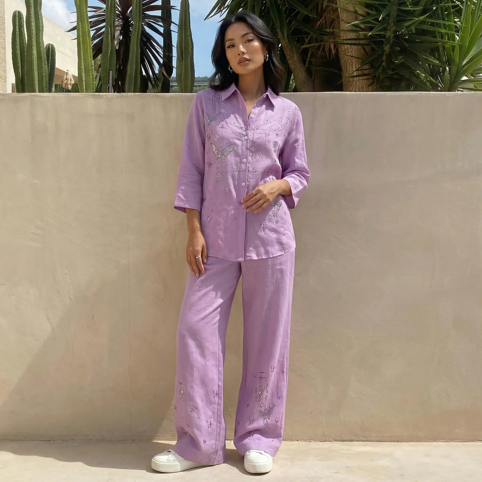 Woman wearing a purple outfit standing against a beige wall with plants in the background, TCH Purple Rhinestone Butterfly Set
