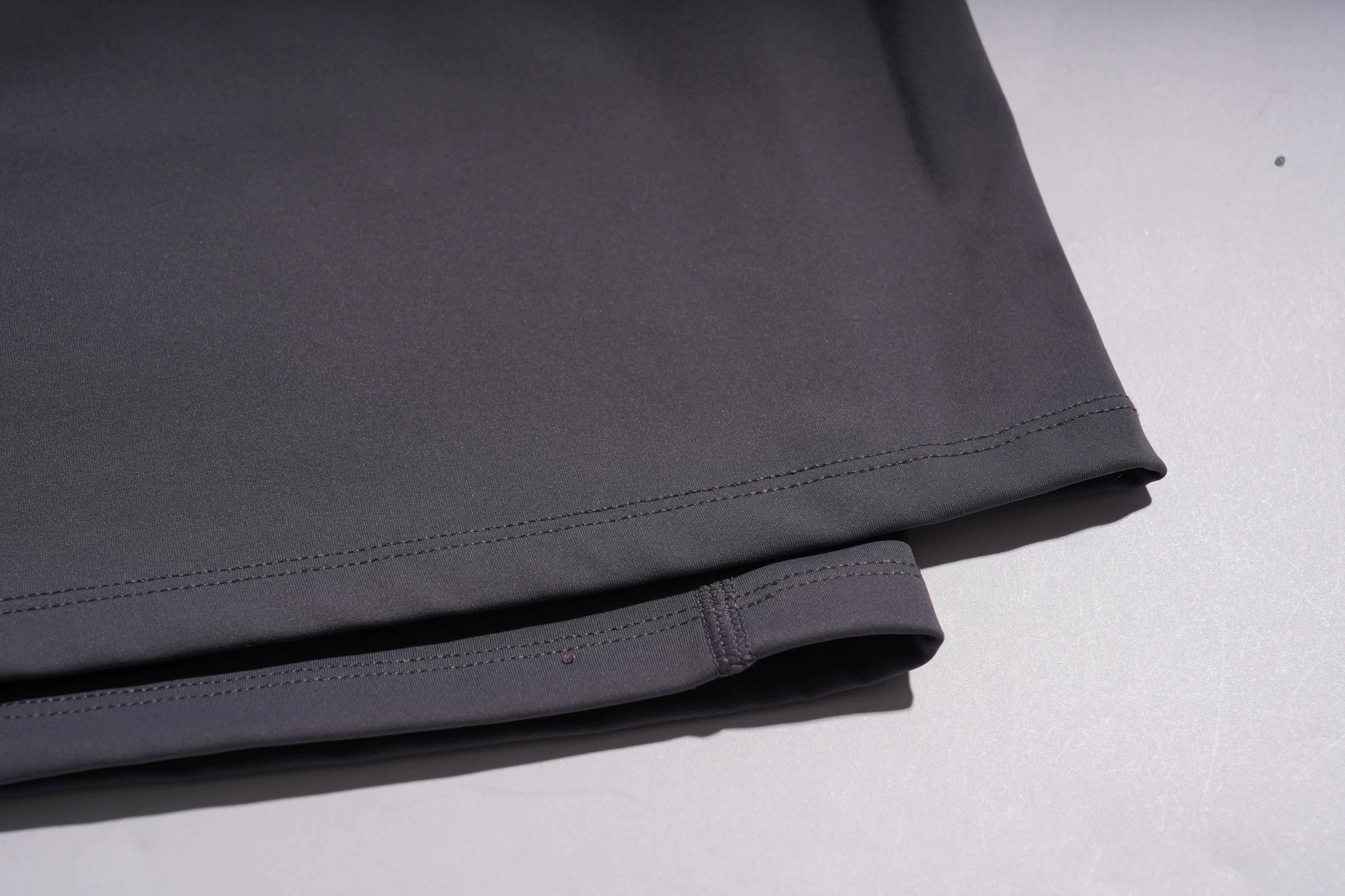 Folded dark gray fabric on a light gray background, TCH Purple Rhinestone Gradient Sweatpants