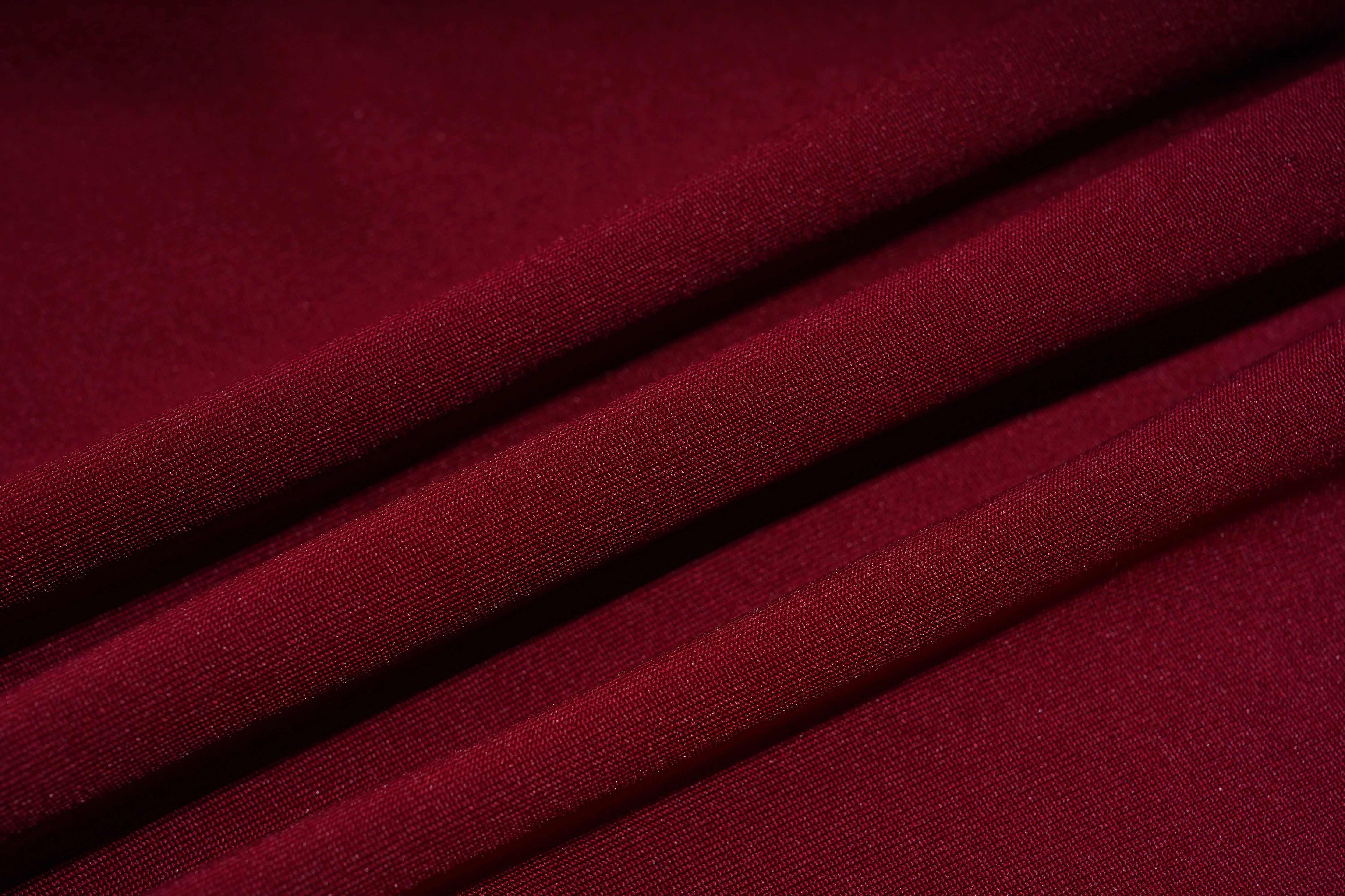 Close-up of red fabric with folds, TCH Red Lace Trim V-Neck Rhinestone Wing Long Sleeve Top