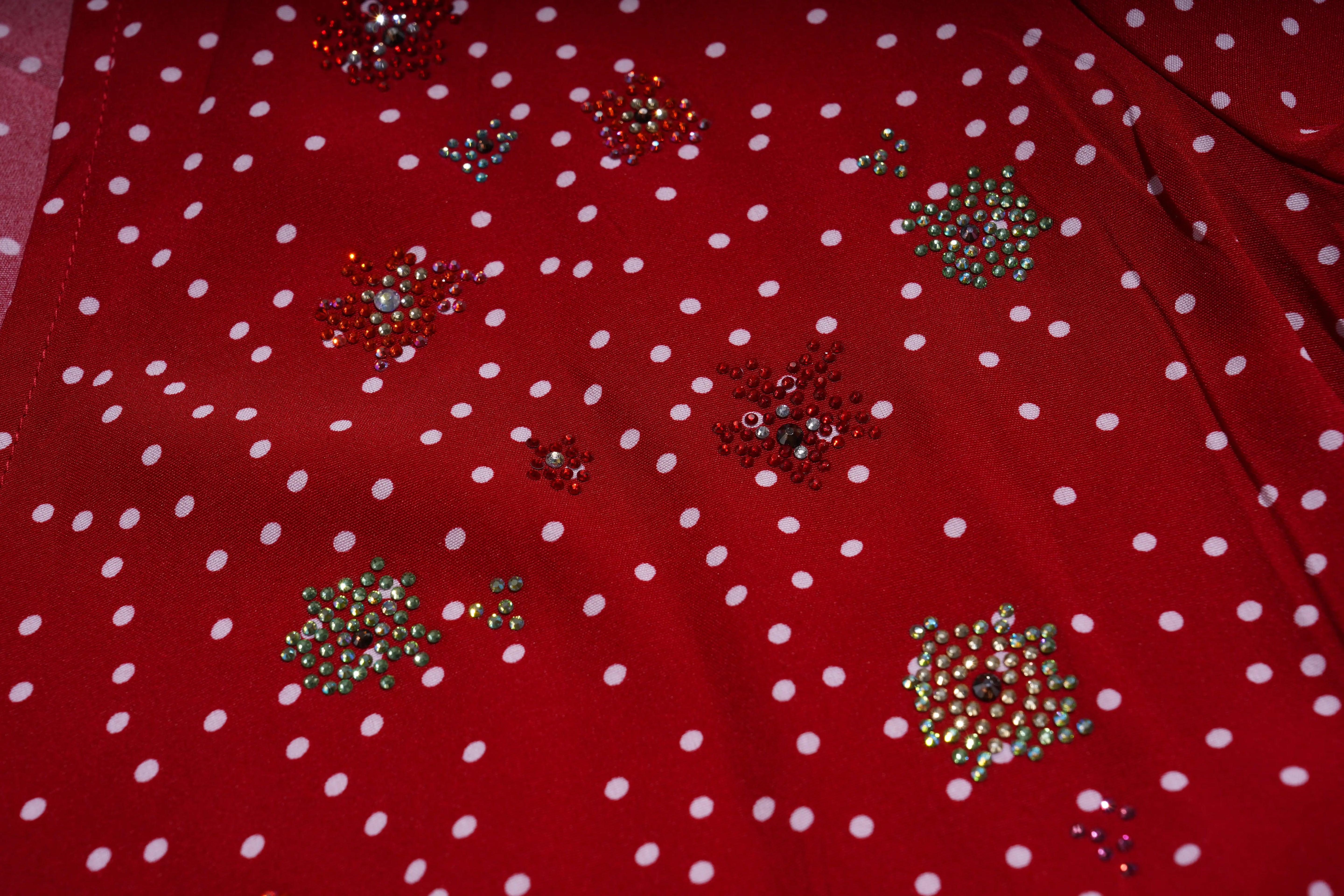 Red fabric with white polka dots and decorative beads on a pink background, TCH Red Polka Dot Rhinestone Flower Dress