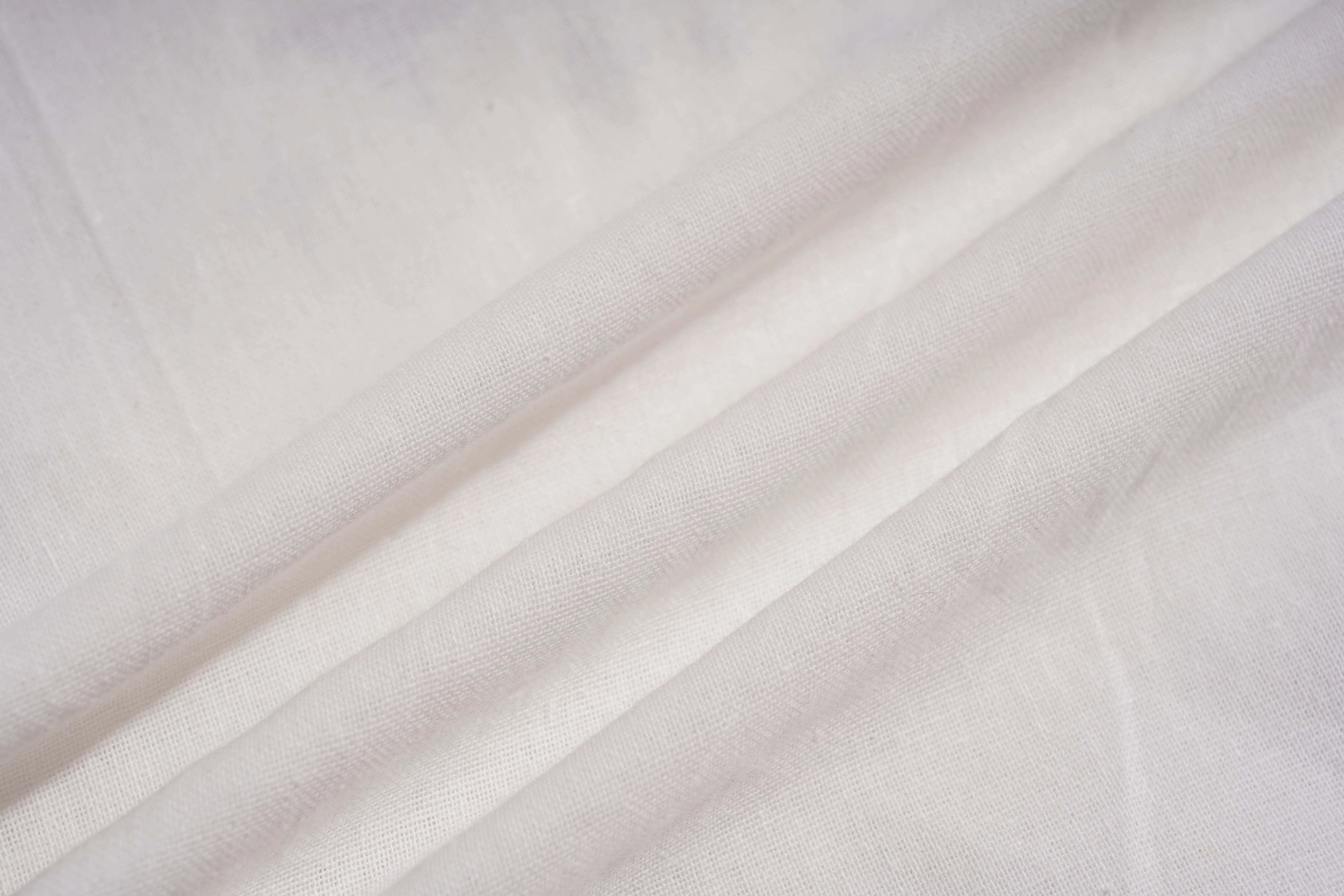 Close-up of light gray fabric with subtle texture, TCH Rhinestone Angel Wings & Cross Set