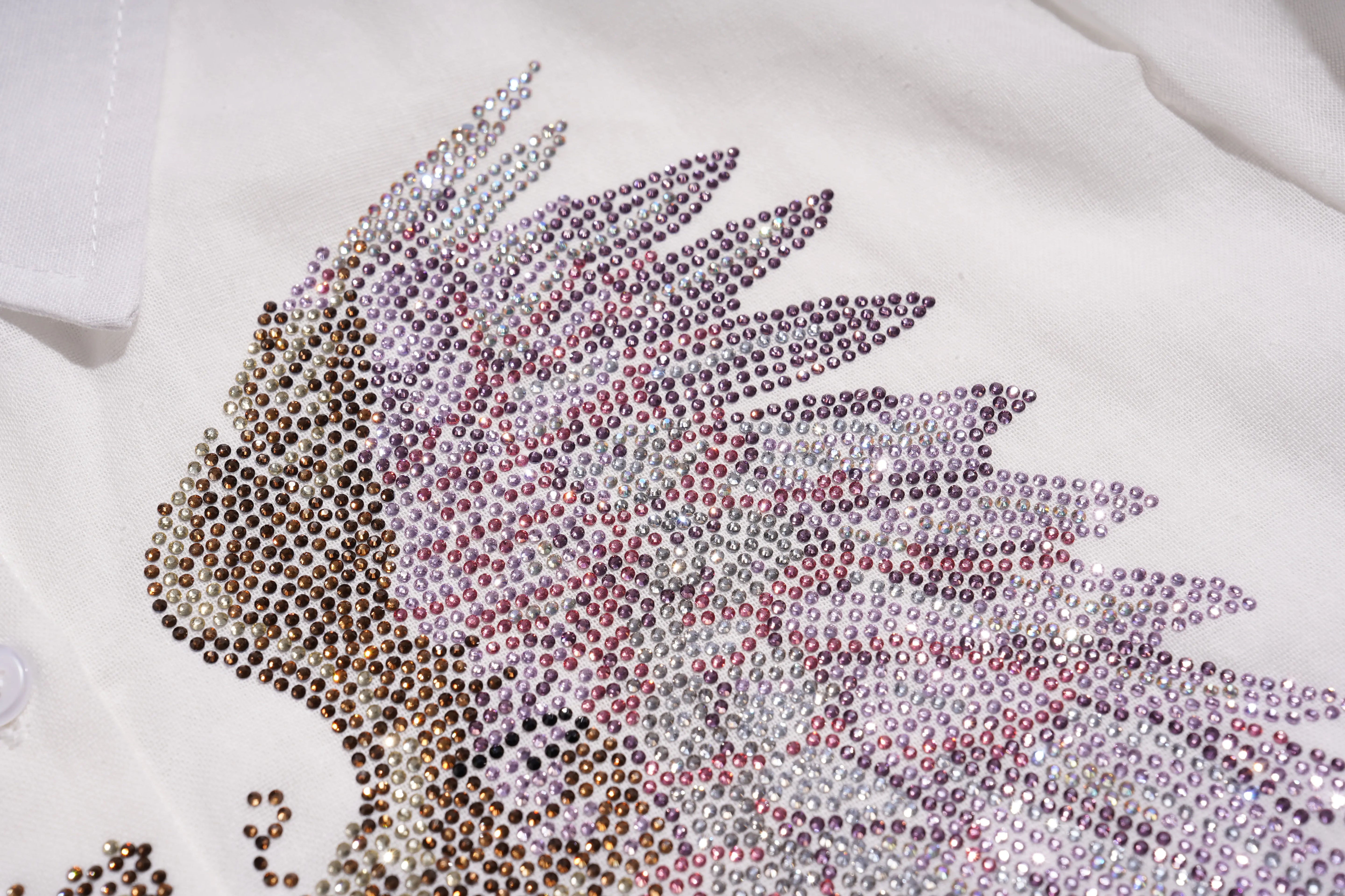 Close-up of a decorative design with rhinestones on a white fabric background, TCH Rhinestone Angel Wings & Cross Set