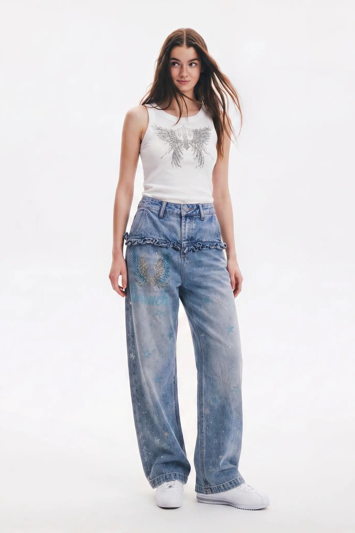 Woman wearing a white sleeveless top with a decorative bow and blue jeans on a white background, TCH Rhinestone Angel Wings Ribbed Tank Top