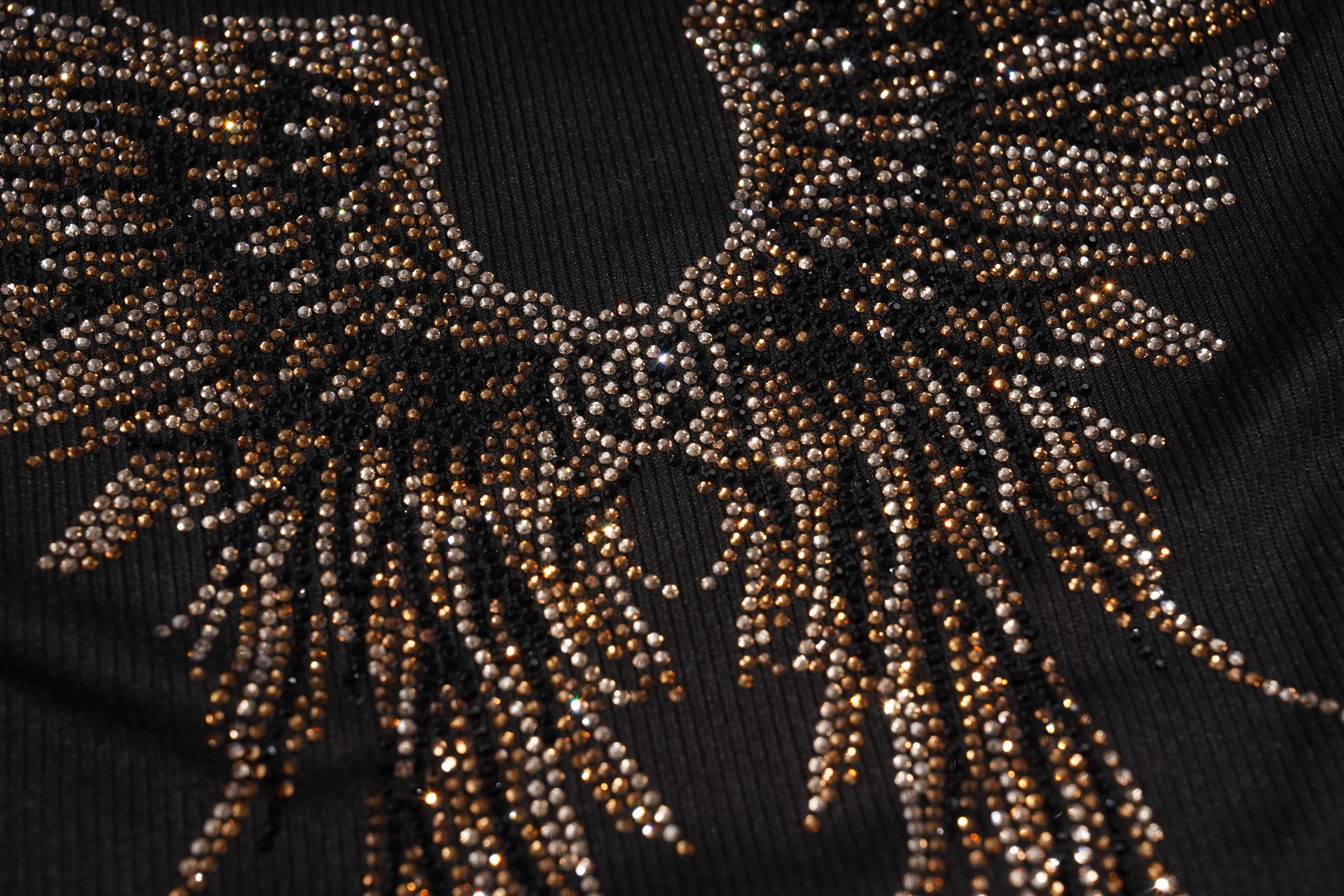 Close-up of a black textile with two bold white stripes running diagonally across the frame, likely part of a garment or accessory. TCH Rhinestone Angel Wings Ribbed Tank Top 