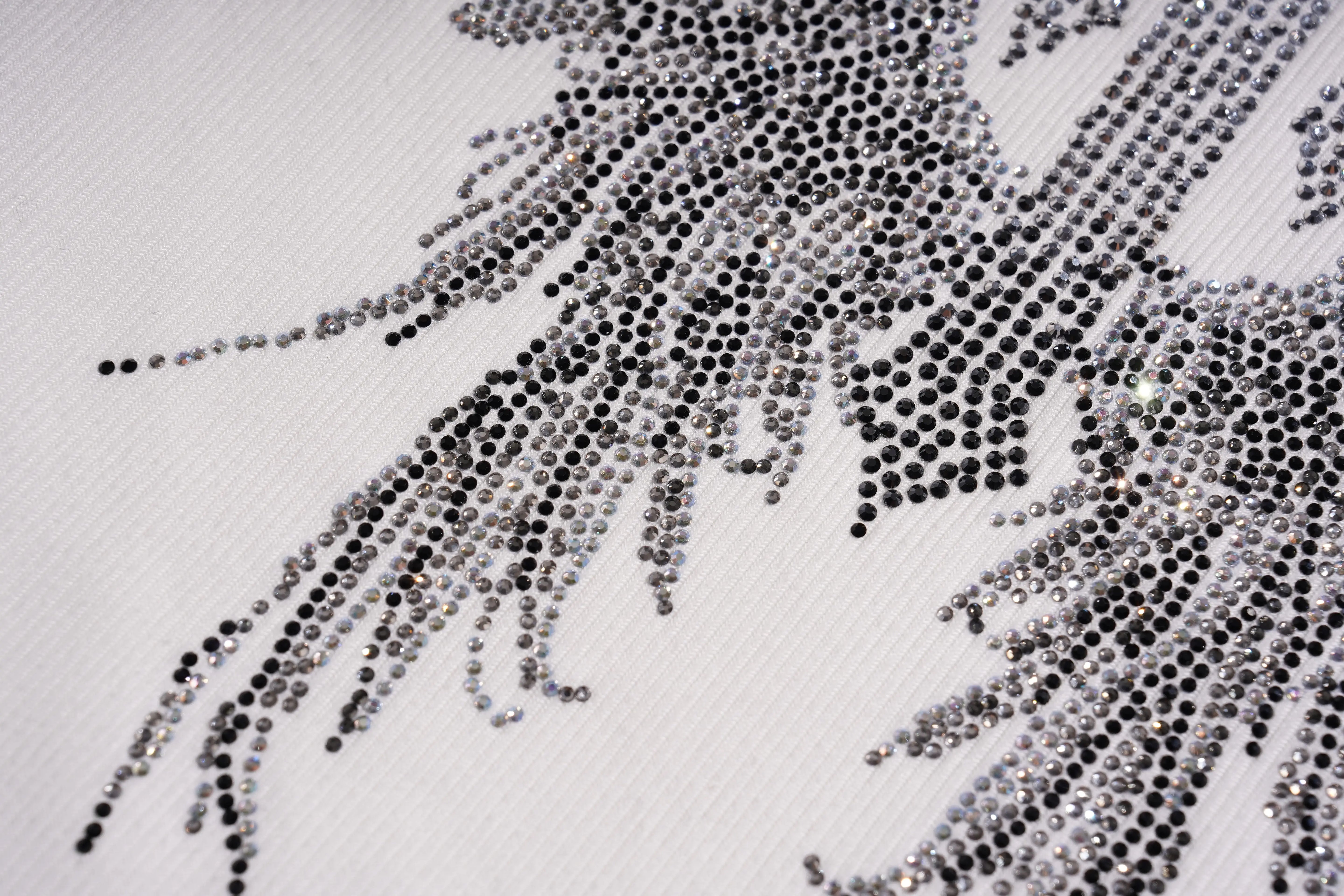 Close-up of a decorative fabric with rhinestones on a white background, TCH Rhinestone Angel Wings Ribbed Tank Top