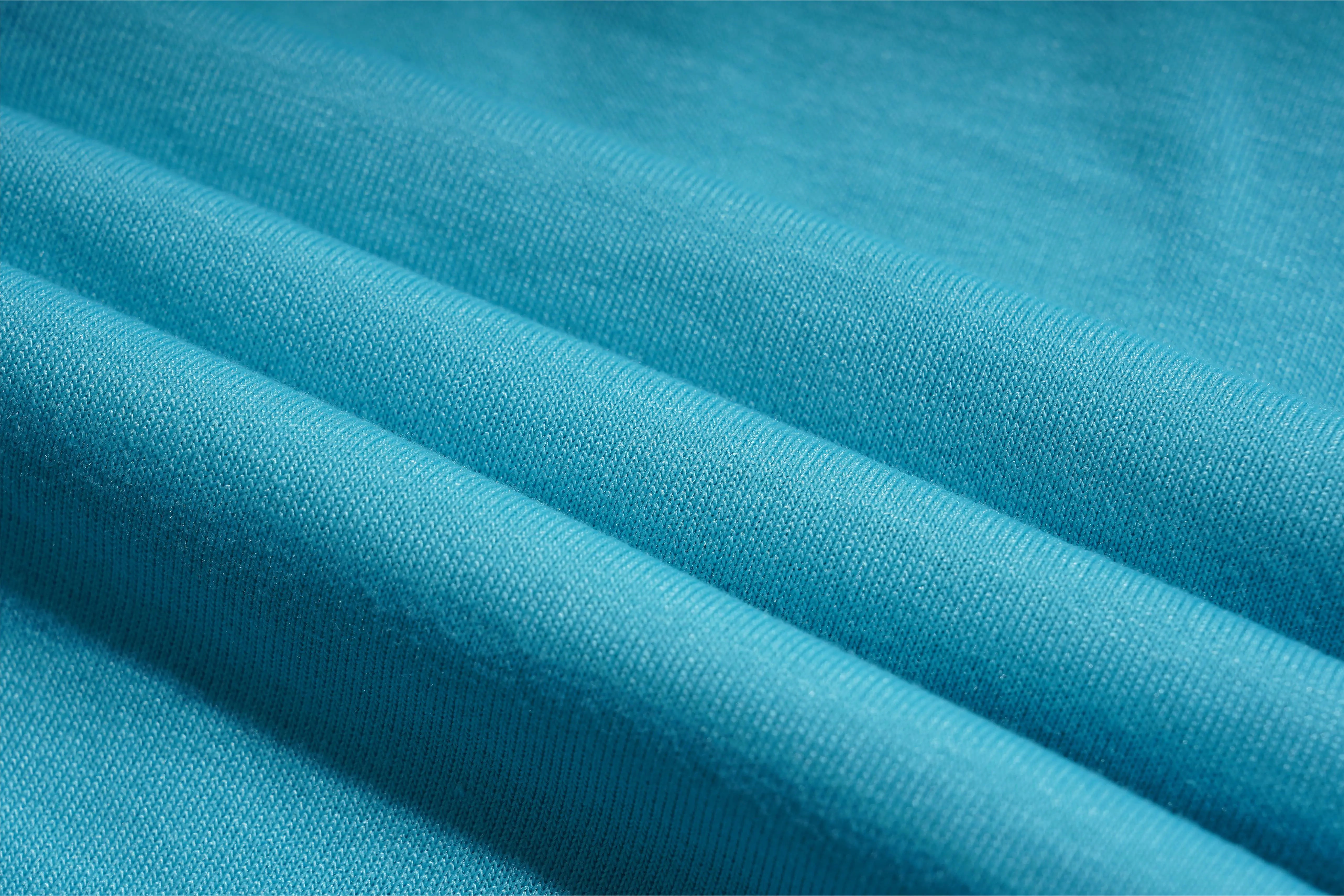 Close-up of blue fabric with visible texture, TCH Rhinestone Angel Wings V-Neck T-Shirt