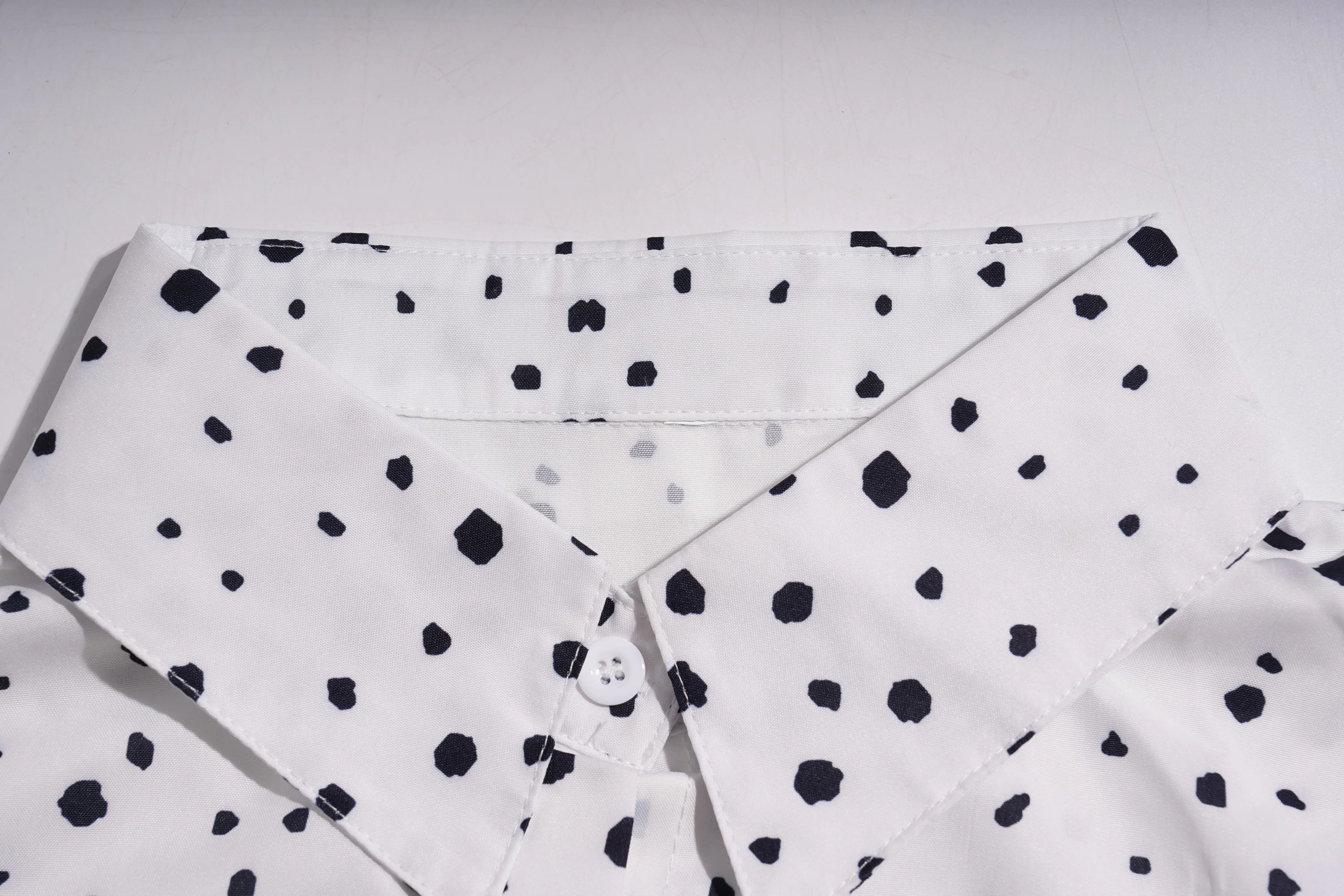 White shirt with black polka dot pattern on a light gray background, TCH Rhinestone Animal Polka Dot Shirt
