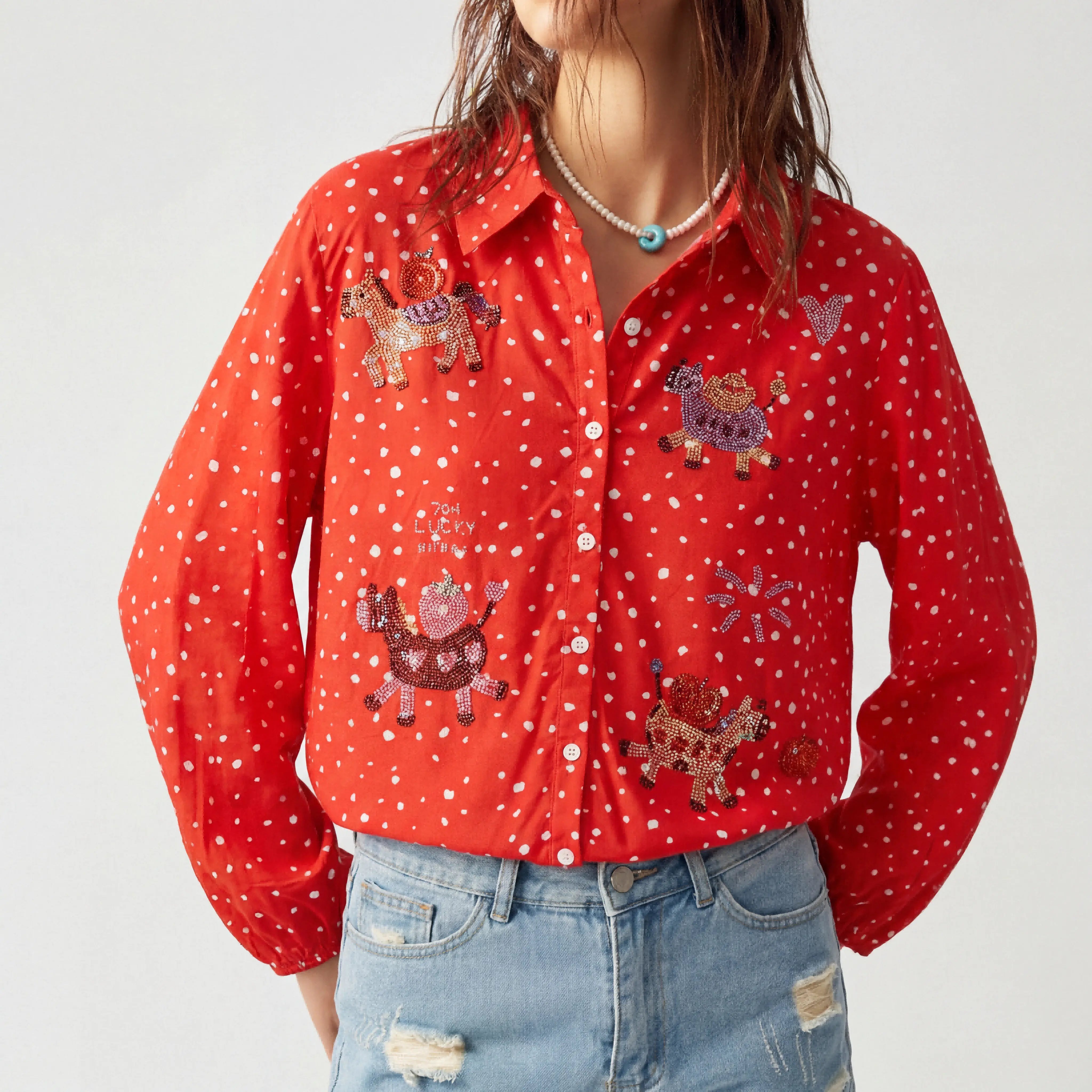 Red shirt with animal patterns and white polka dots worn by a person on a light gray background, TCH Rhinestone Animal Polka Dot Shirt