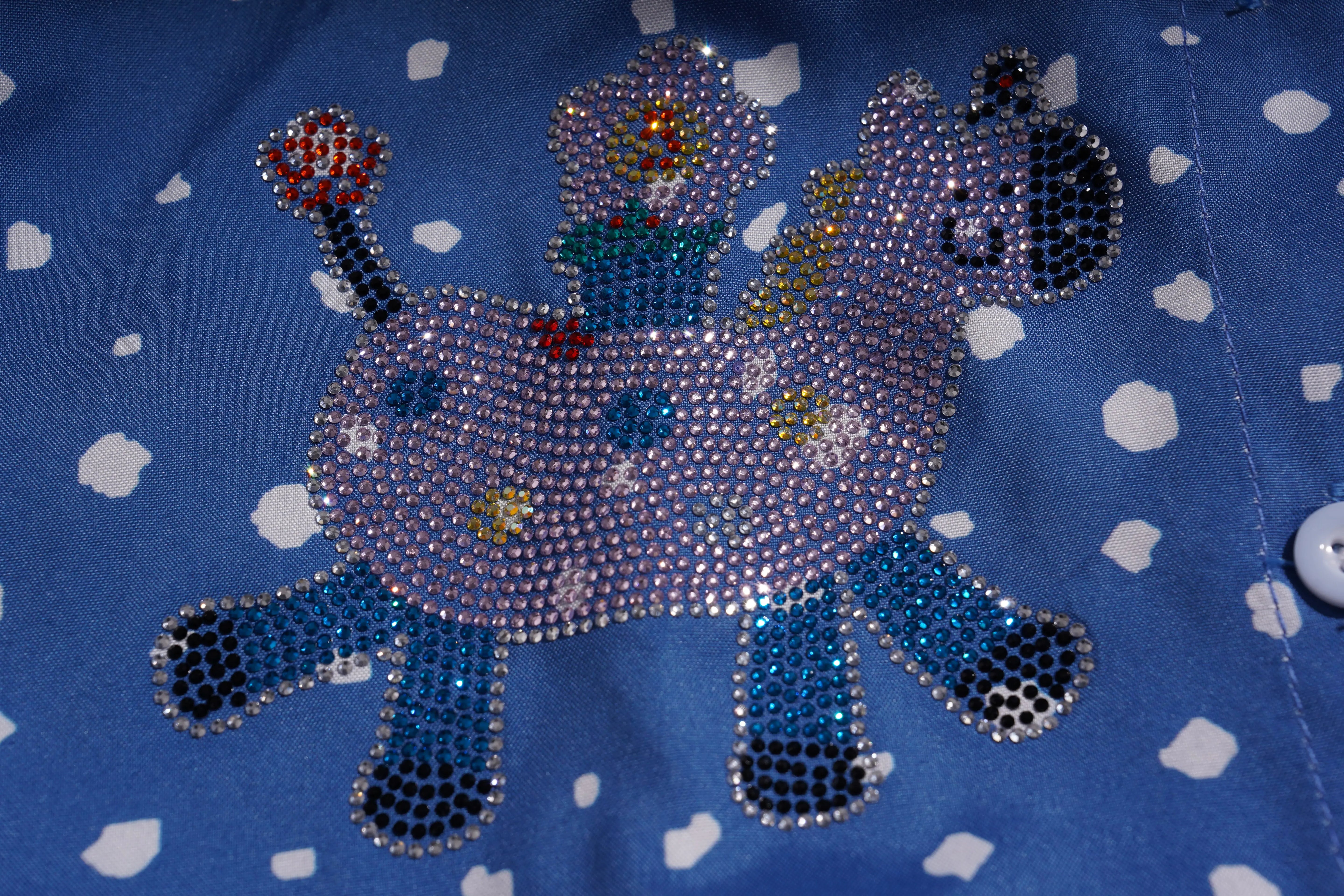 Decorative animal design with rhinestones on a blue fabric background, TCH Rhinestone Animal Polka Dot Shirt