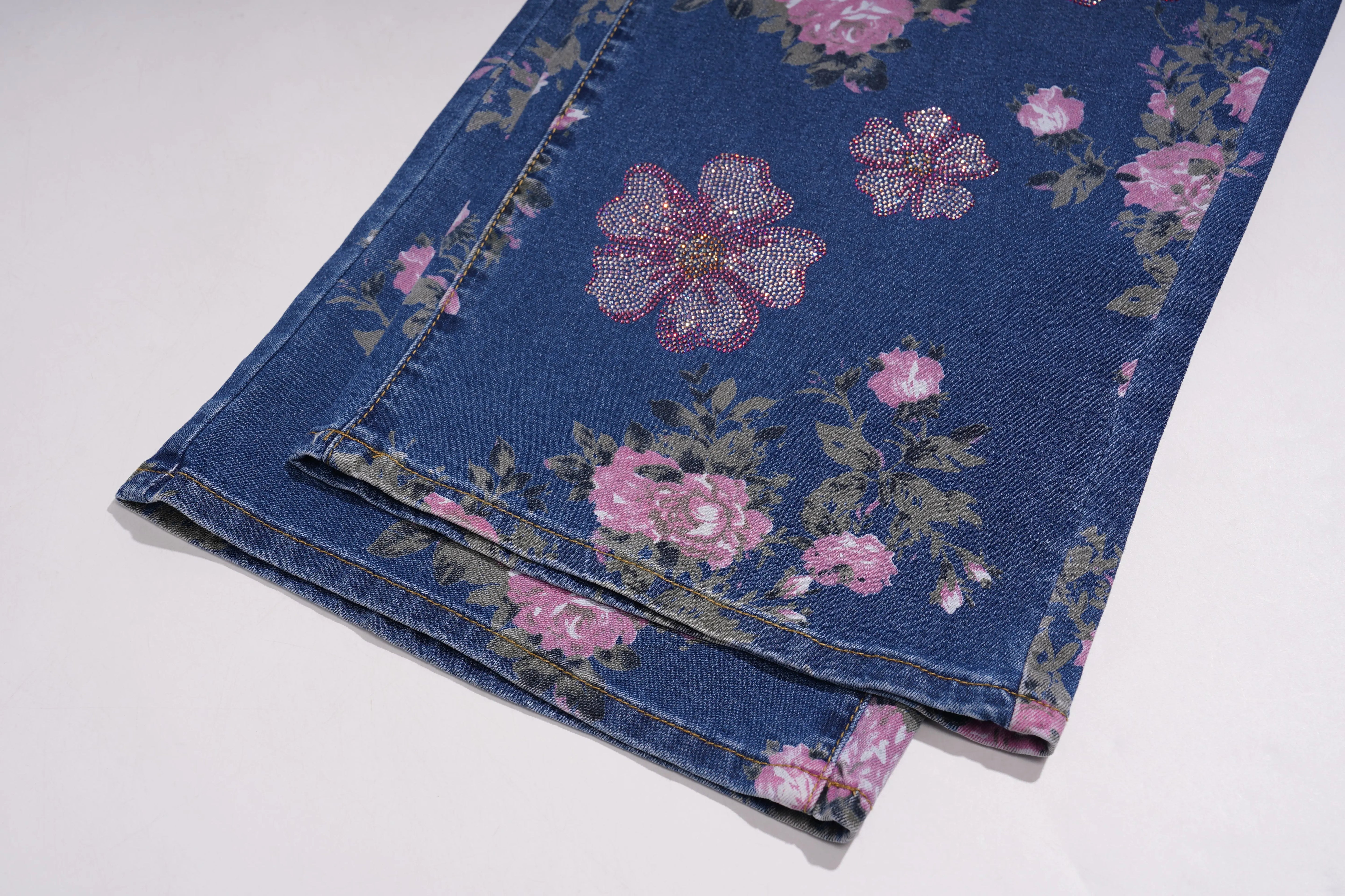 Folded denim fabric with floral pattern on a white background, TCH Rhinestone Blossom Print Denim Jeans