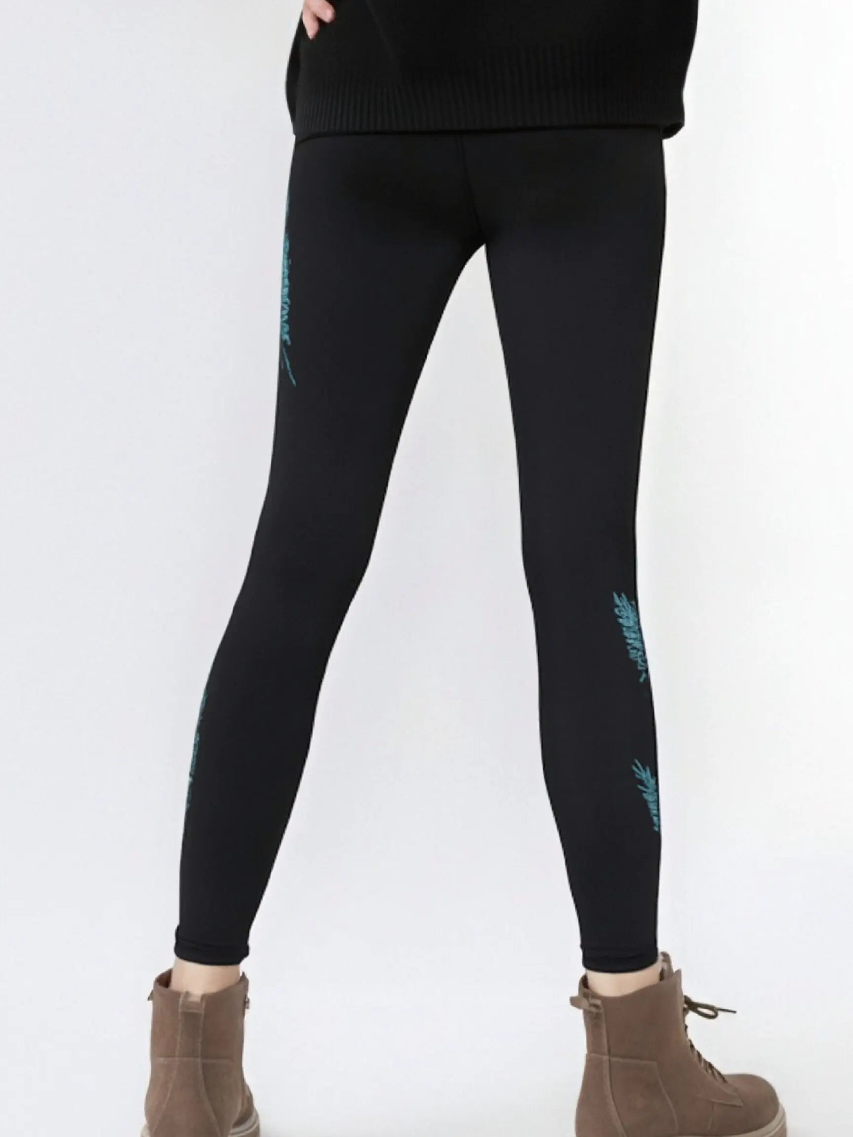 Black leggings with teal designs worn by a person on a white background, TCH Rhinestone Blue Wings Black High-Waist Leggings