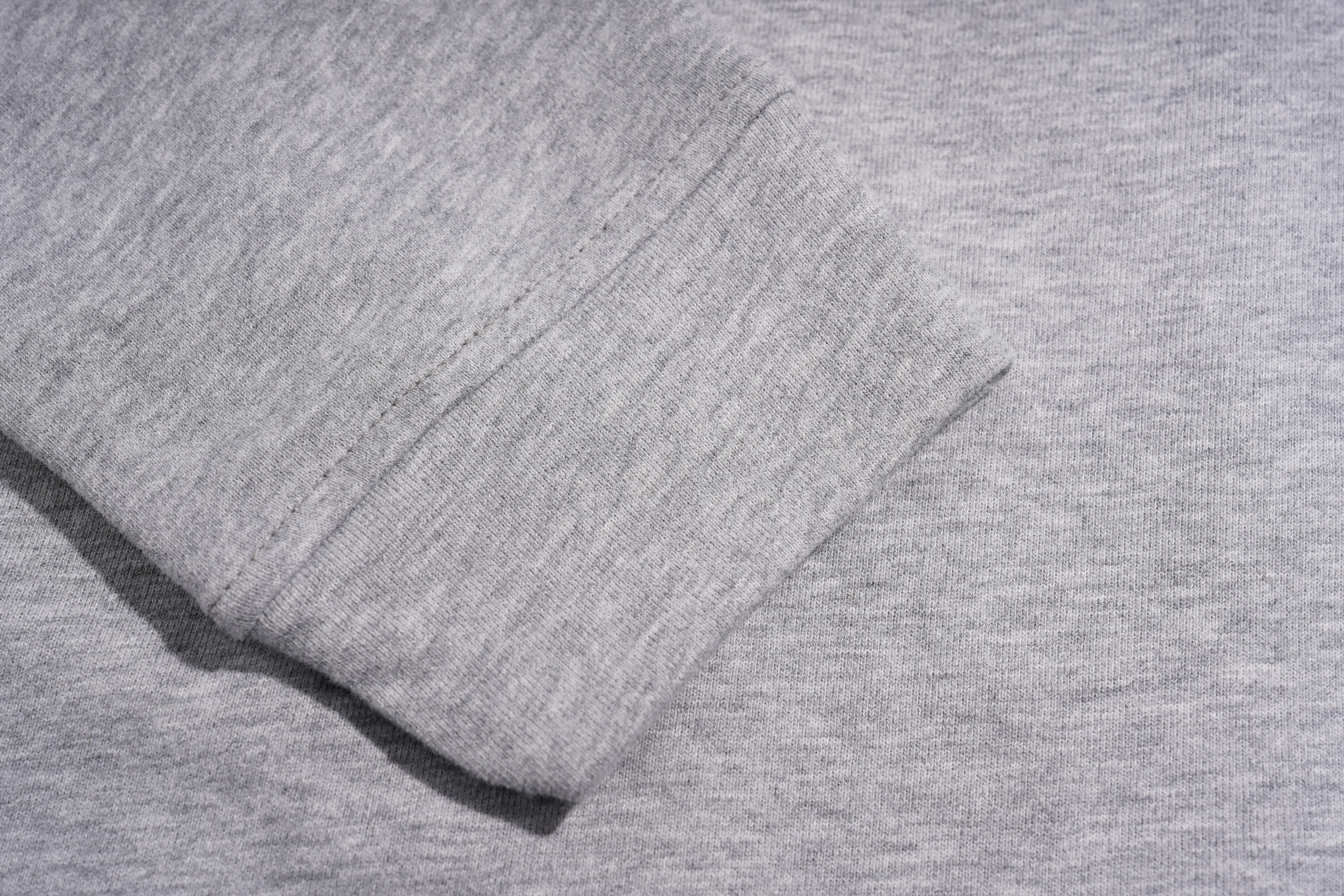 Close-up of a light gray heathered fabric, showing a folded cuff or hem with visible stitching on a matching textured background. TCH Rhinestone Bow 3-Piece Lounge Set