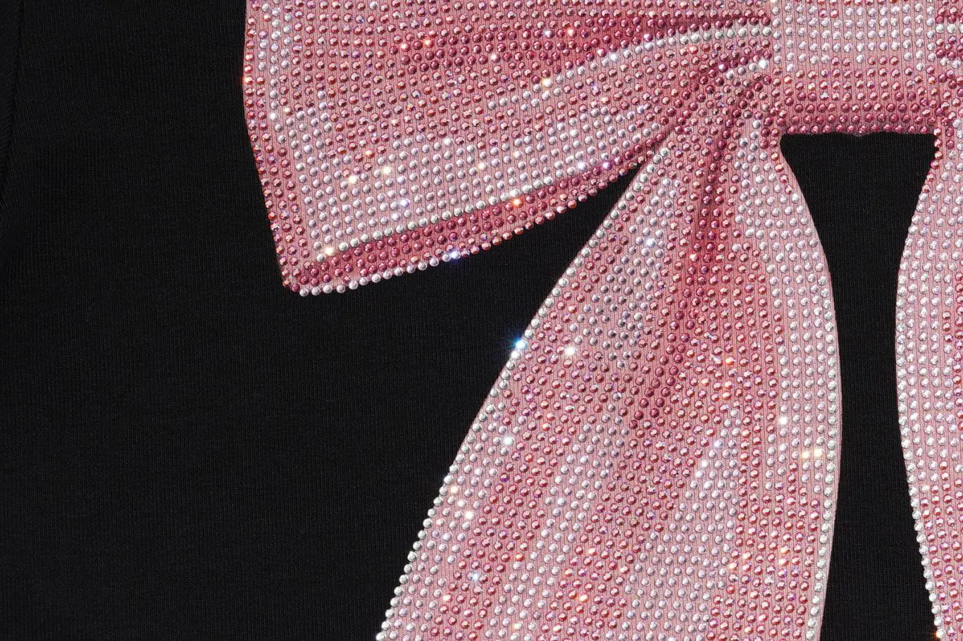 A close-up of a large pink bow embellished with sparkling rhinestones, set against a solid black background. TCH Rhinestone Bow Collar Black Mini Dress