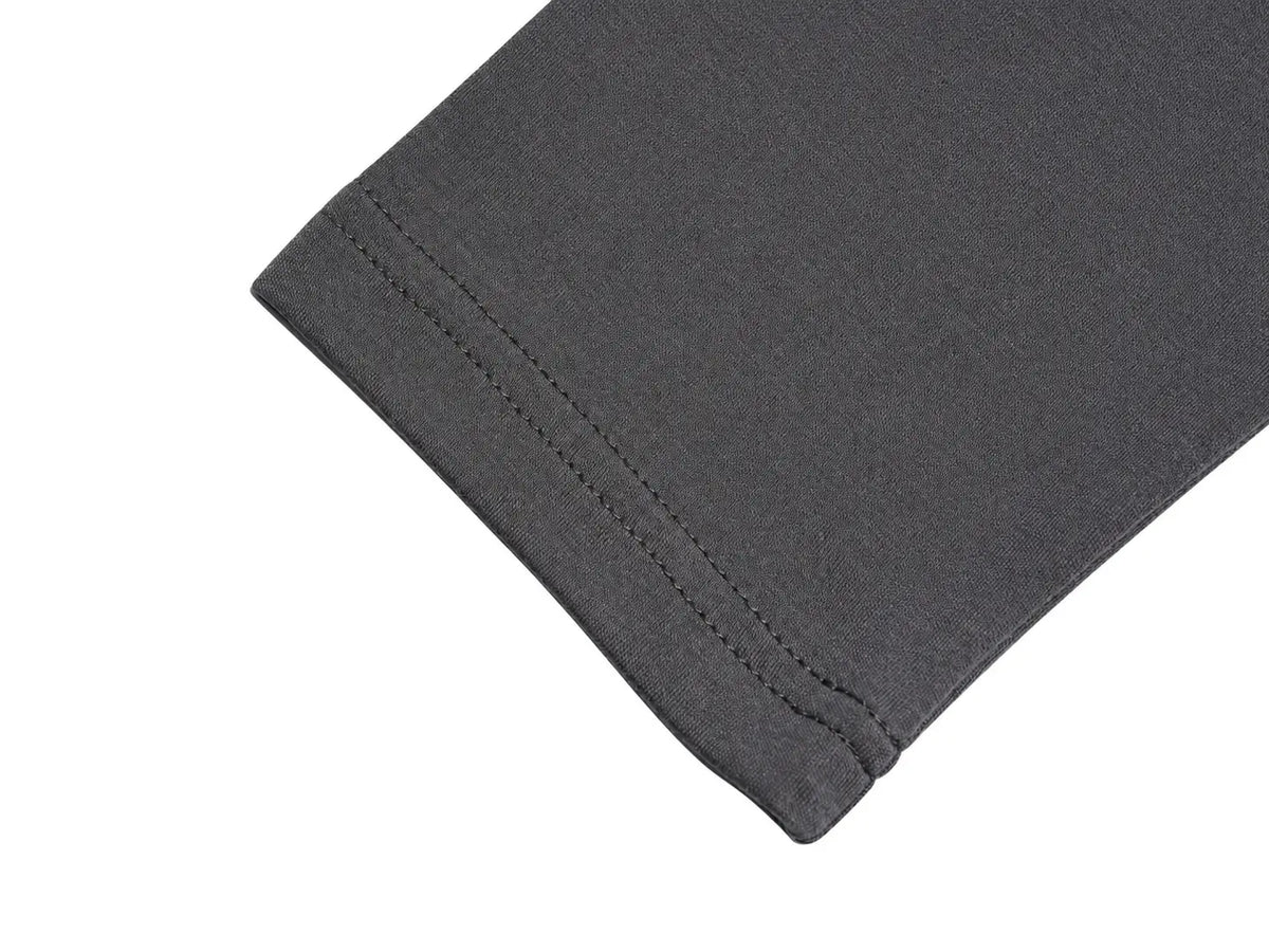 Close-up of a dark gray fabric cuff with neat double stitching on a plain white background. TCH Rhinestone Bow Graphic Fitted Long Sleeve Top