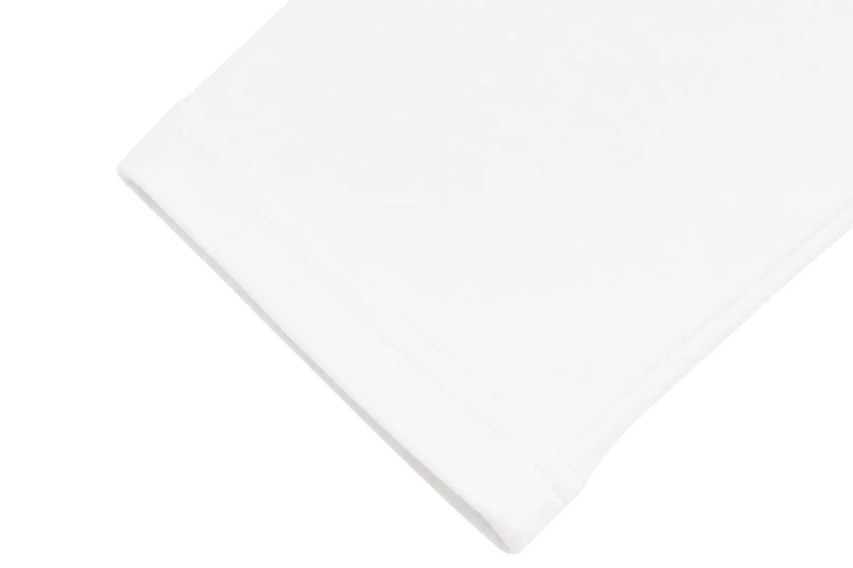 A close-up of a folded white fabric item, likely a t-shirt sleeve or bandana, showing a subtle tonal embroidered pattern on a clean white background. TCH Rhinestone Bow Graphic Fitted Long Sleeve Top