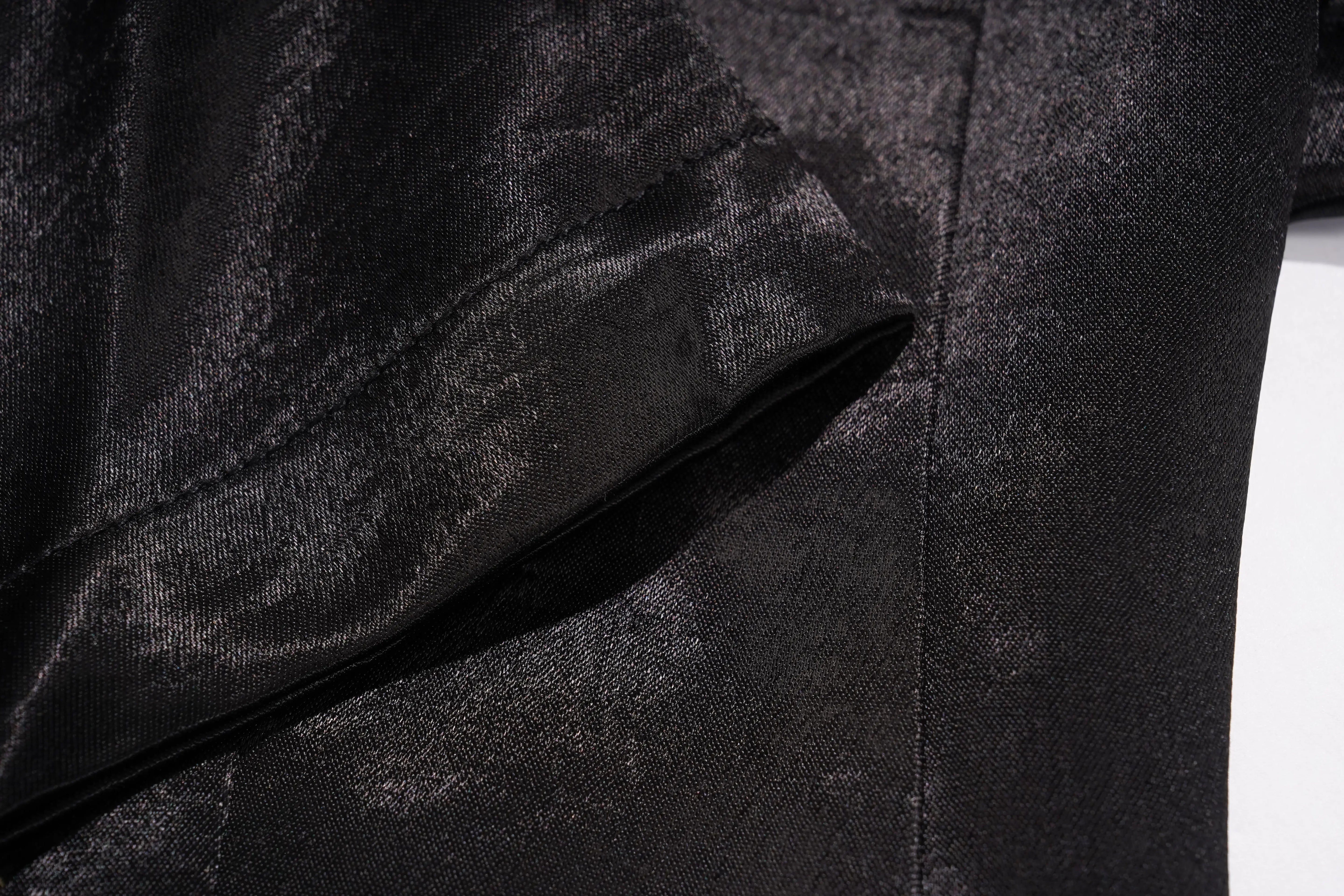 A close-up of draped brown fabric with soft folds and a smooth, matte texture. TCH Rhinestone Bow Satin Blazer