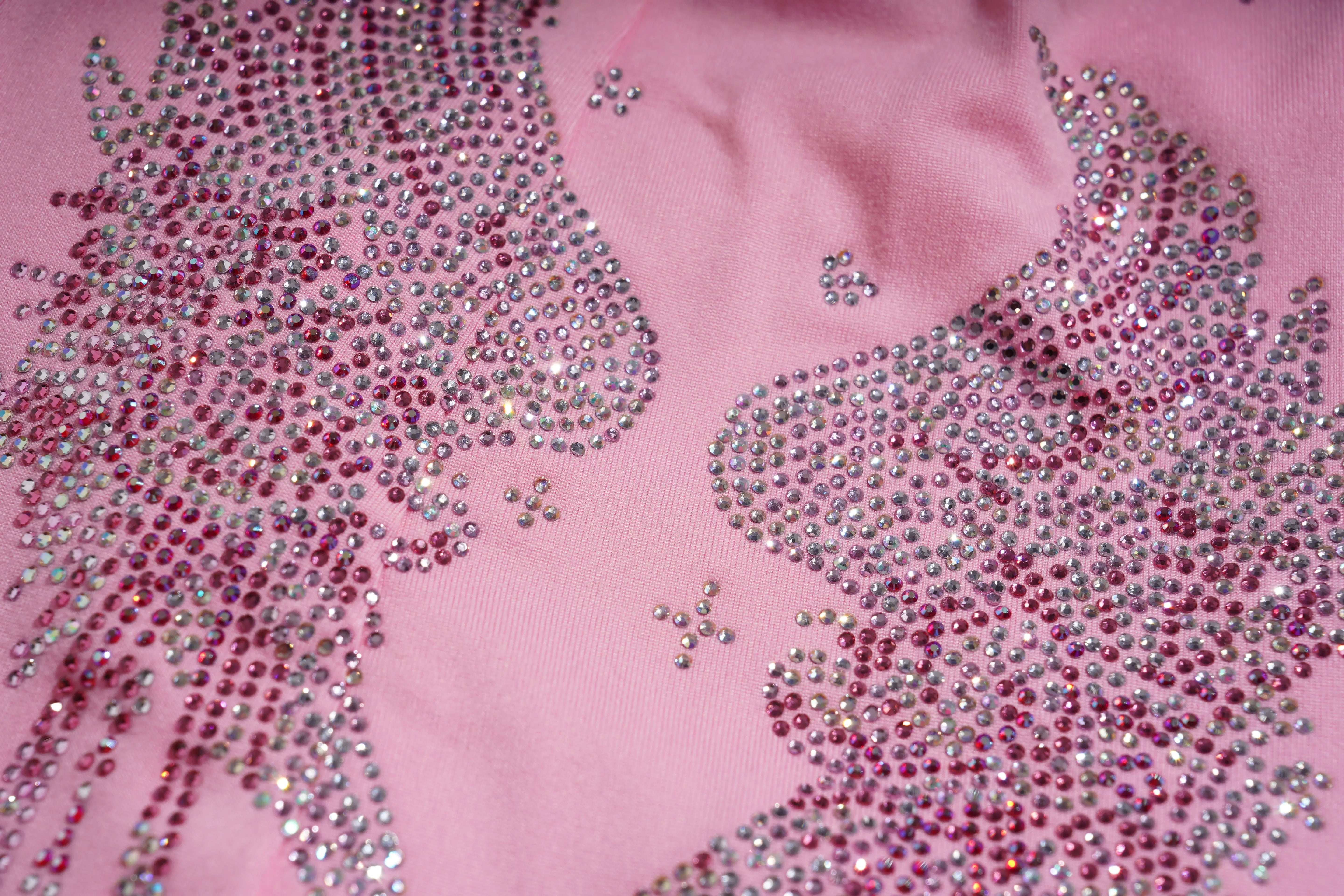 Pink fabric with decorative pink and silver rhinestone patterns, TCH Rhinestone Bow & Wing Set