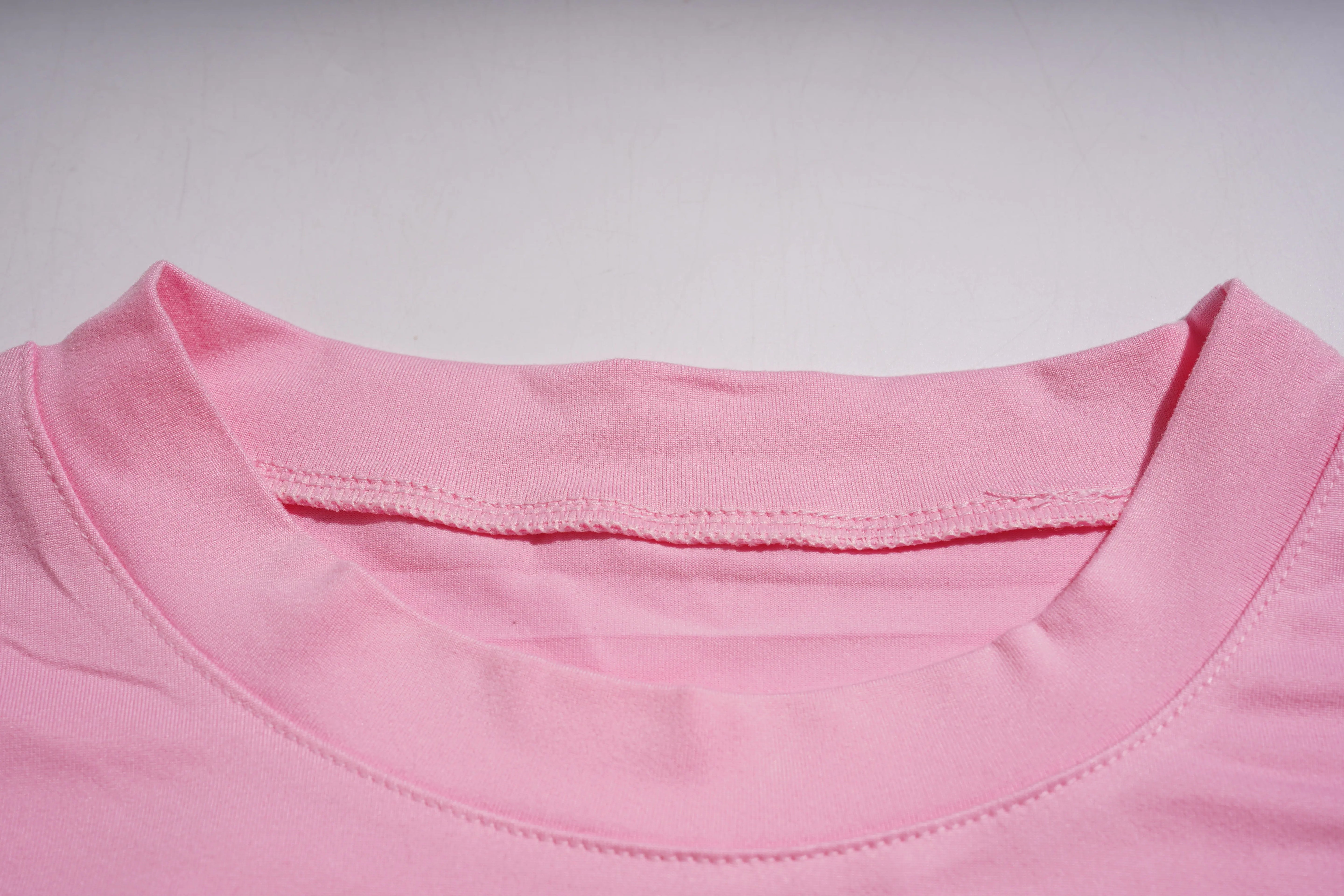 Close-up of a pink shirt collar on a light gray background, TCH Rhinestone Bow & Wing Set