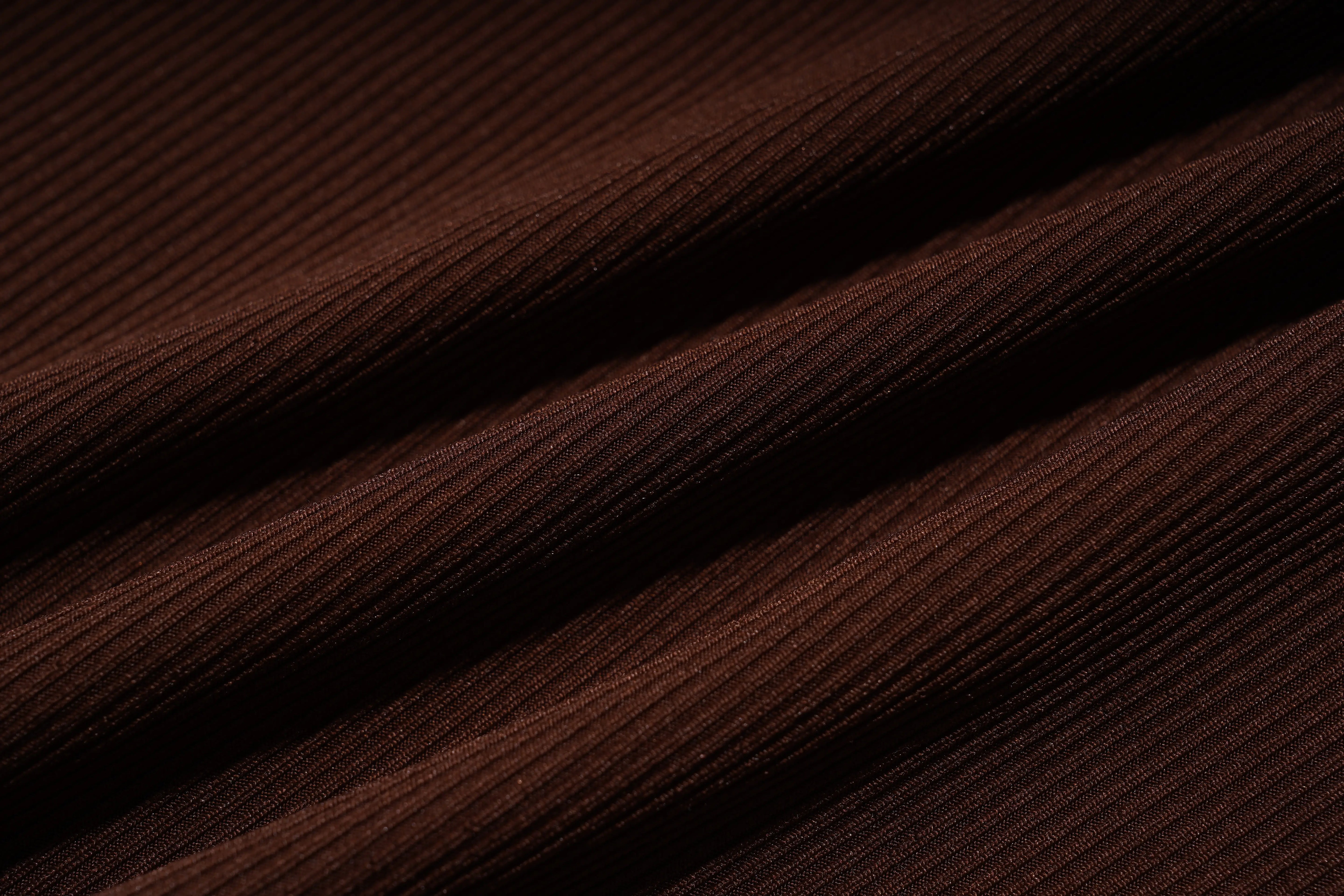 Close-up of brown fabric with visible texture, TCH Rhinestone Butterfly Bow Tank Top