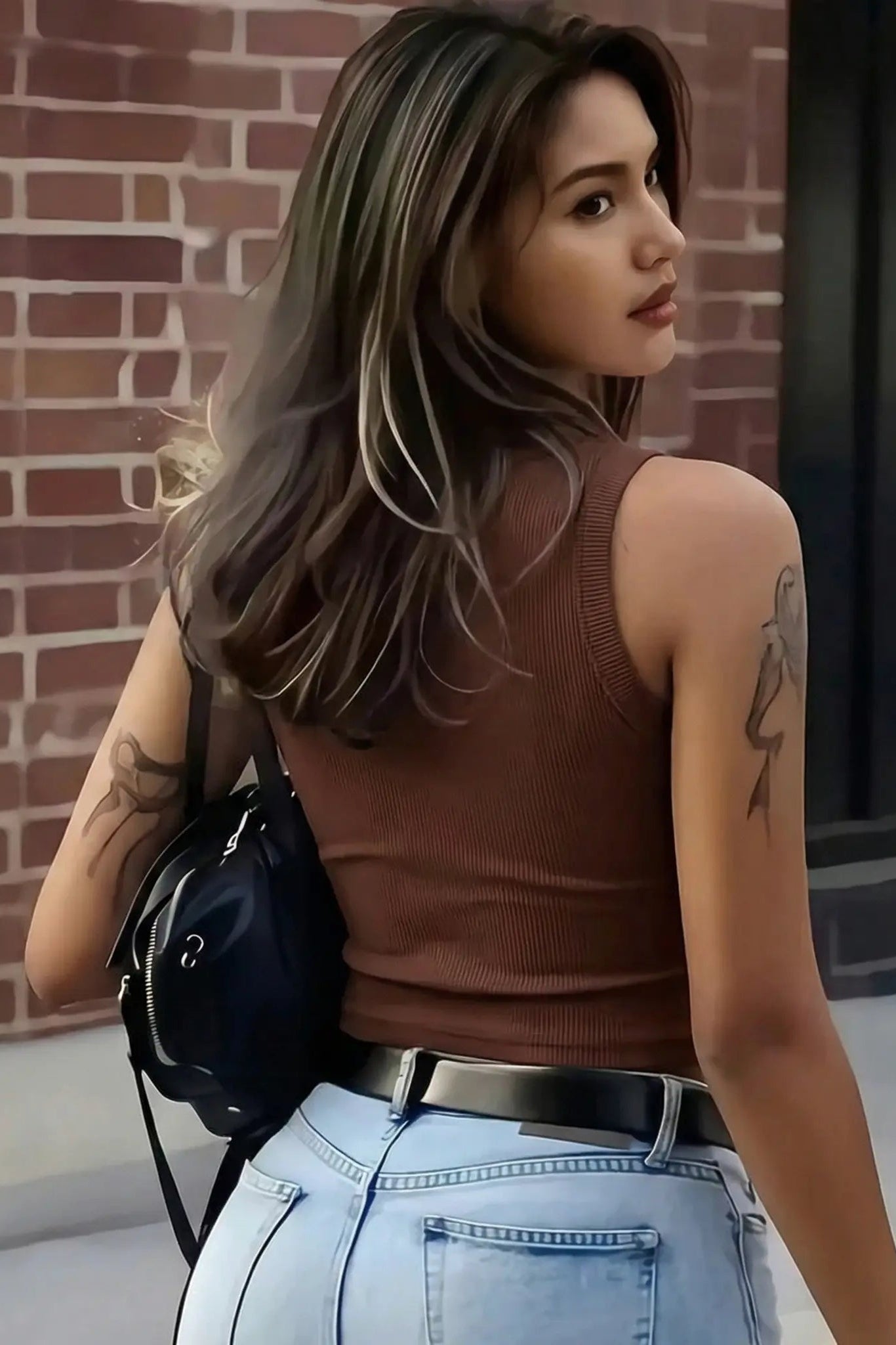 Woman wearing a brown sleeveless top and light blue jeans, standing against a brick wall. TCH Rhinestone Butterfly Bow Tank Top