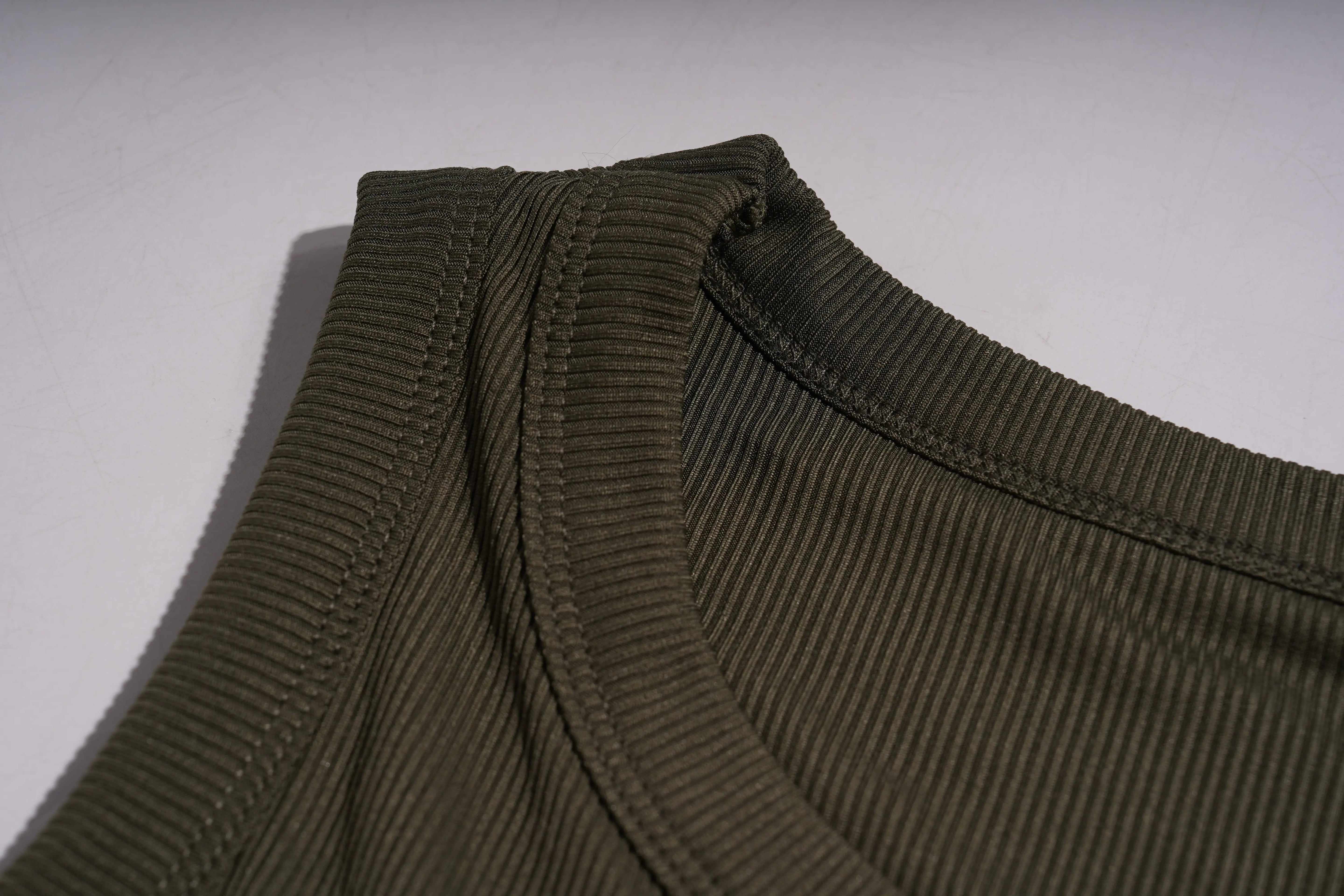 Close-up of a ribbed neckline on a garment with a neutral background, TCH Rhinestone Butterfly Bow Tank Top