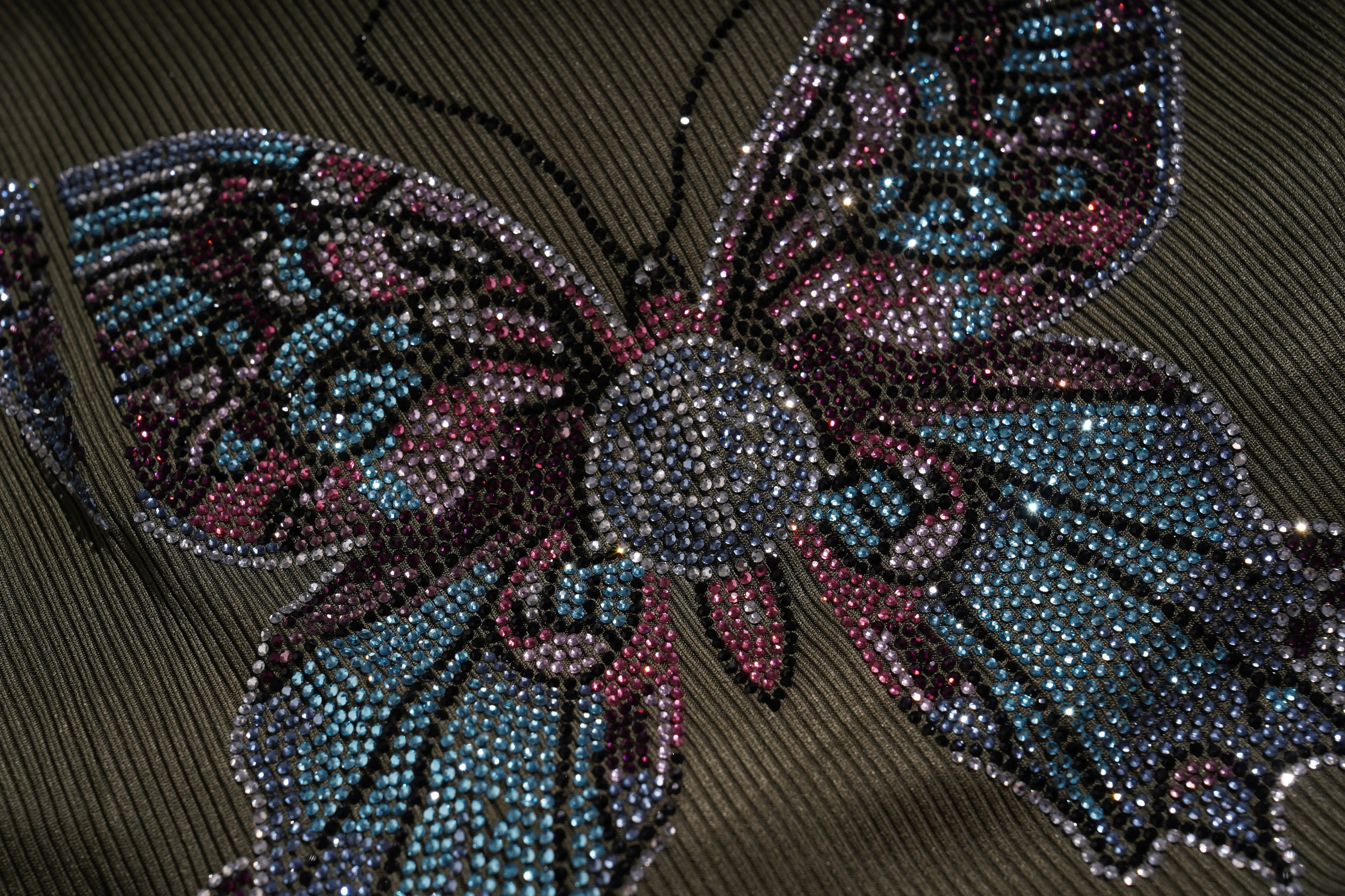 Butterfly-shaped decorative item with rhinestones on a textured surface, TCH Rhinestone Butterfly Bow Tank Top