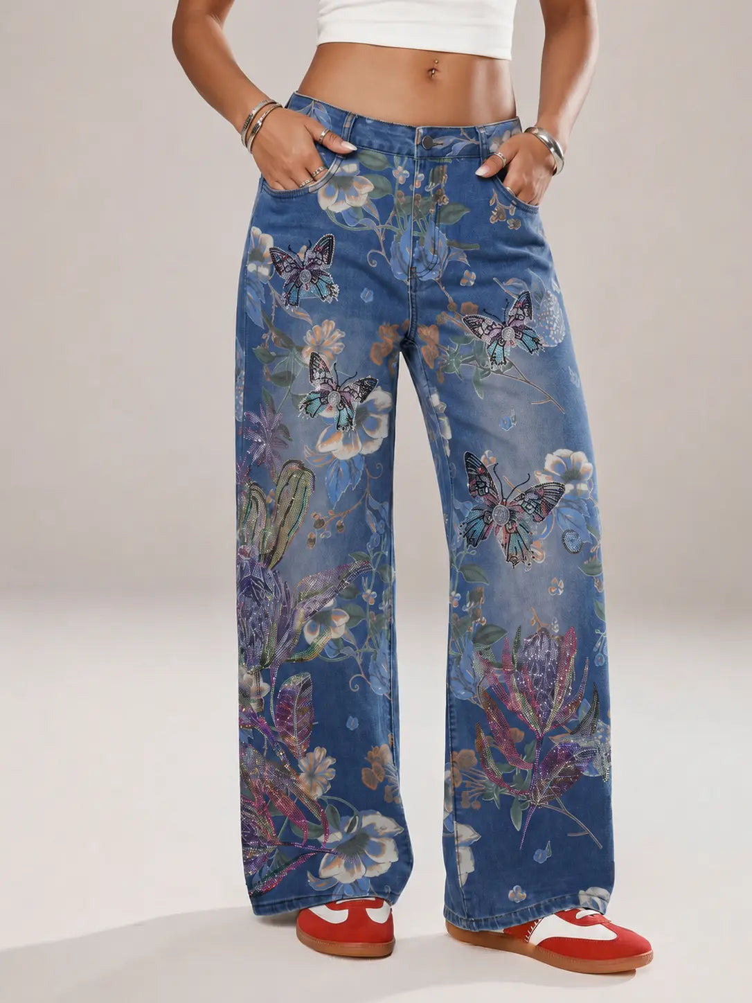Blue floral-patterned pants worn by a person on a plain background, TCH Rhinestone Butterfly Floral Print Denim Jeans